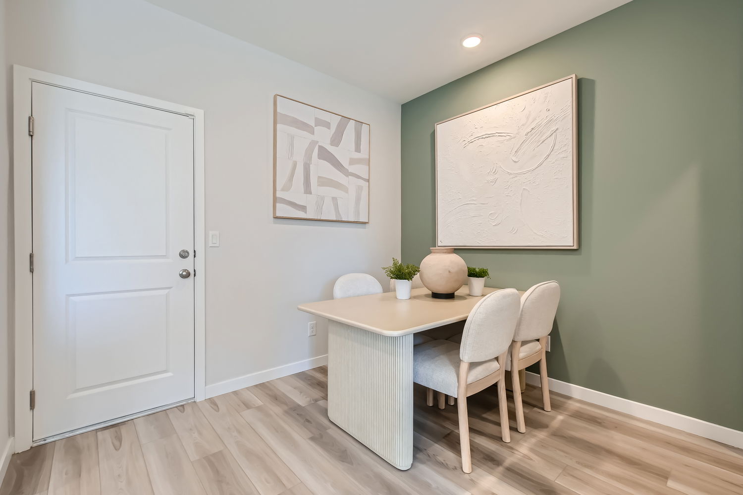 A room with a table and chairs.