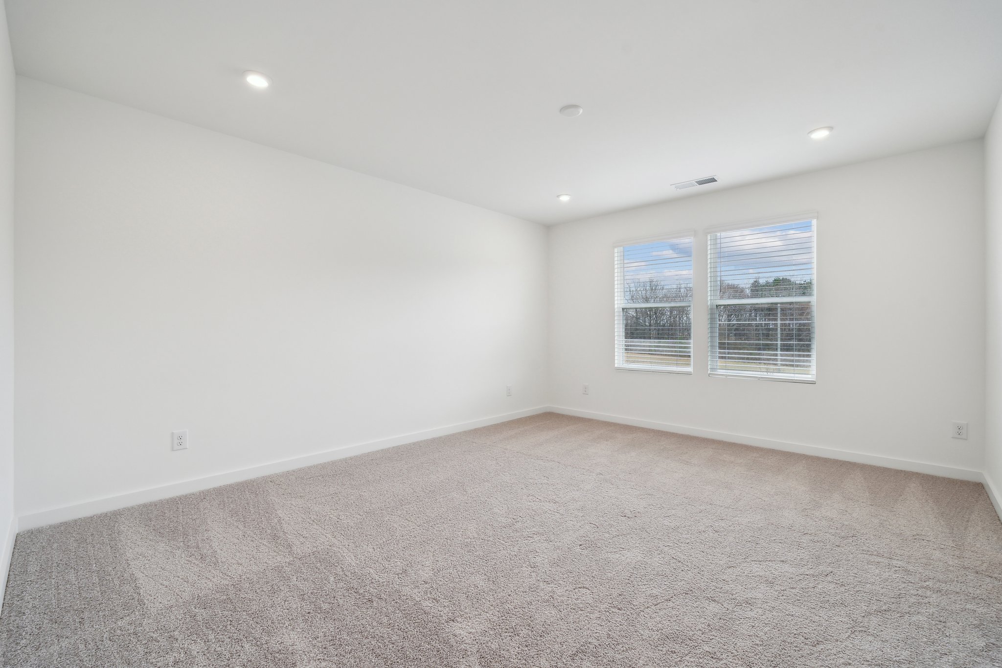 A room with a window and a carpet.