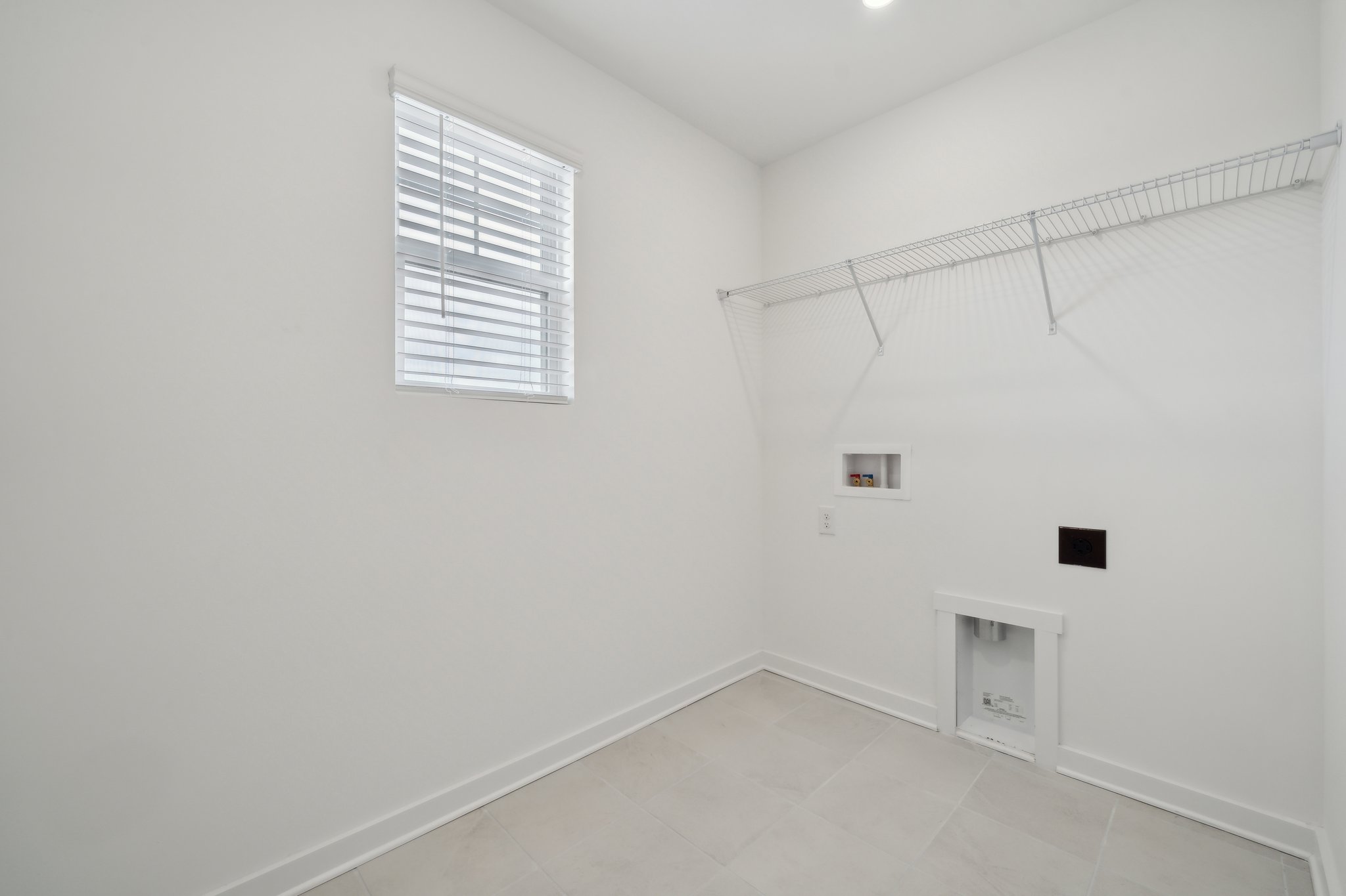 A white room with a window.