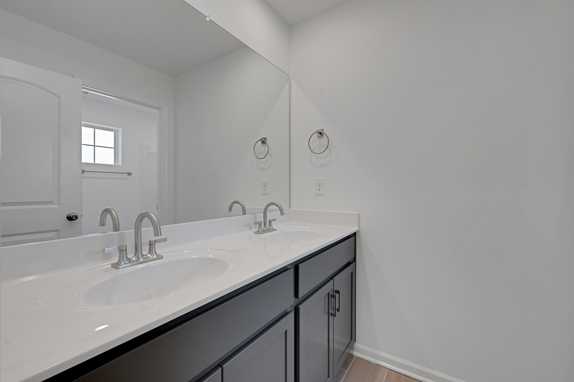 A bathroom with a large mirror.