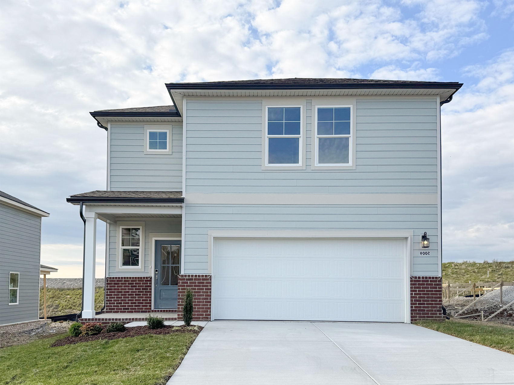 A white house with a garage.