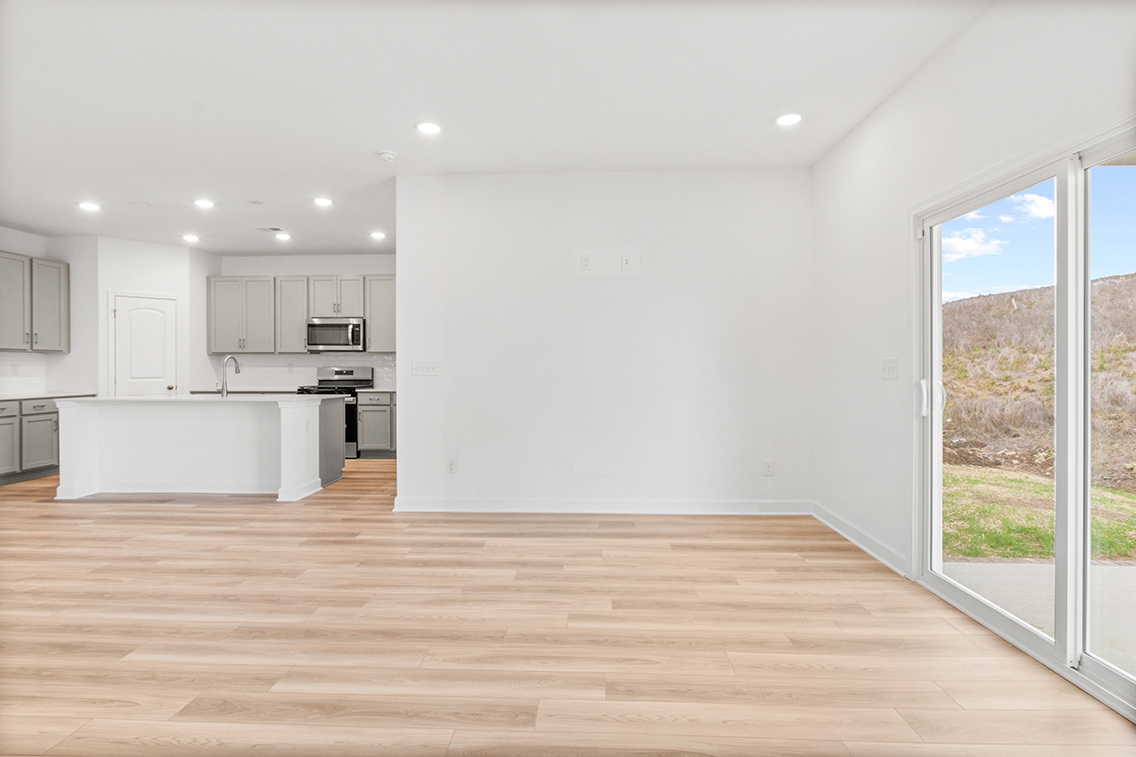 A kitchen with a wood floor.