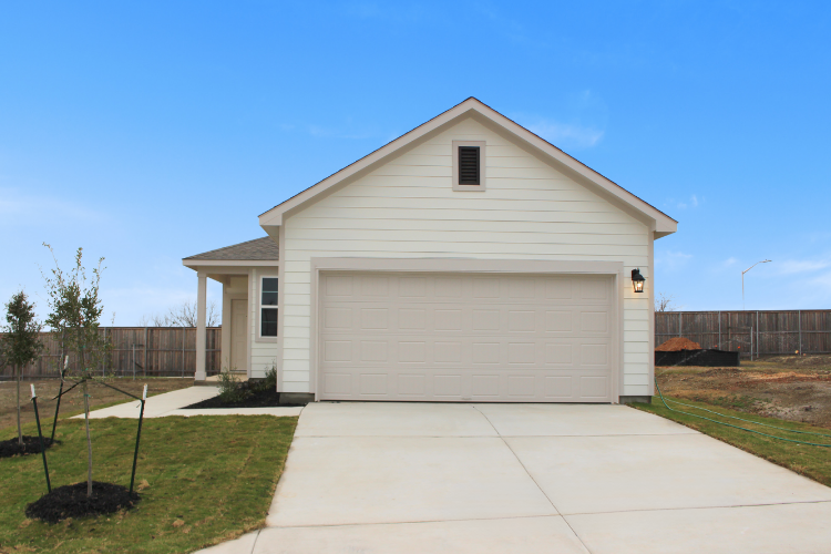 A white house with a garage.