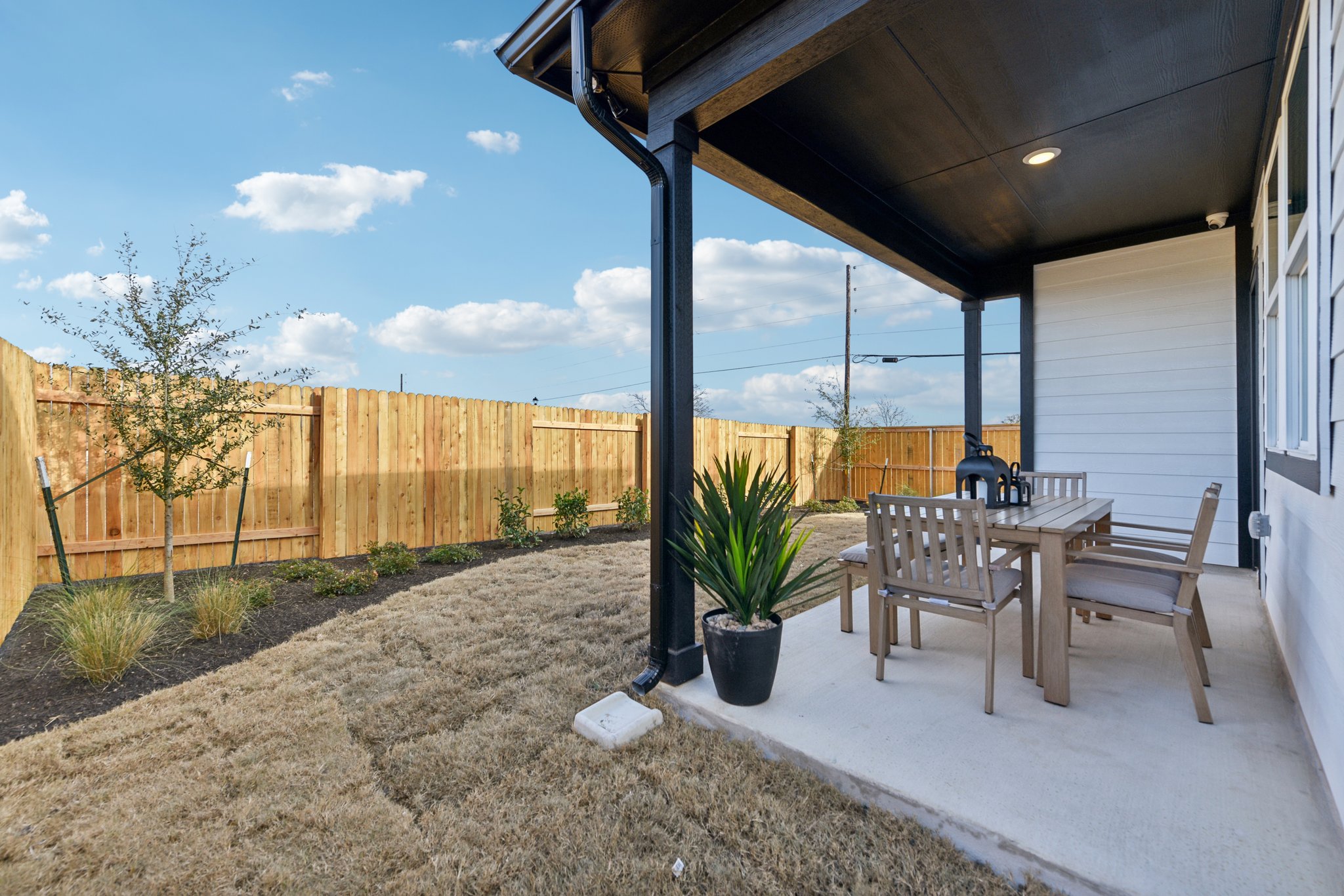 A patio with a table and chairs.