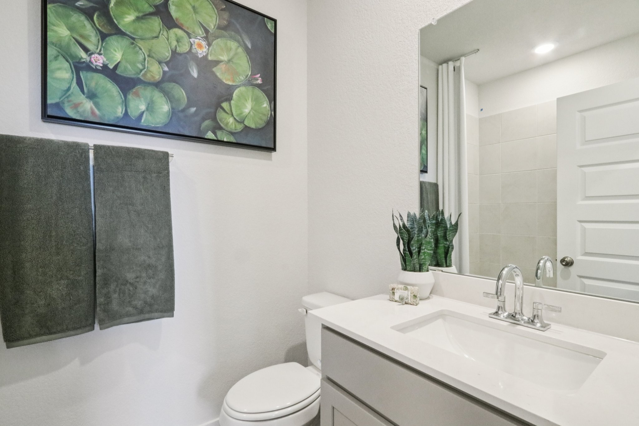 A bathroom with a sink and a toilet.