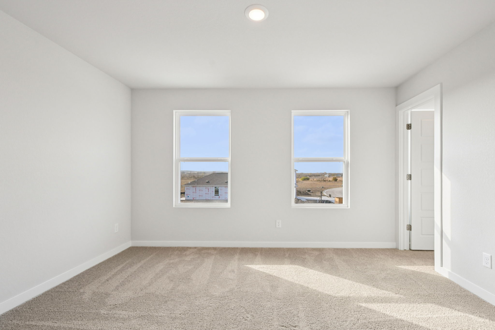 A room with a window and a door.