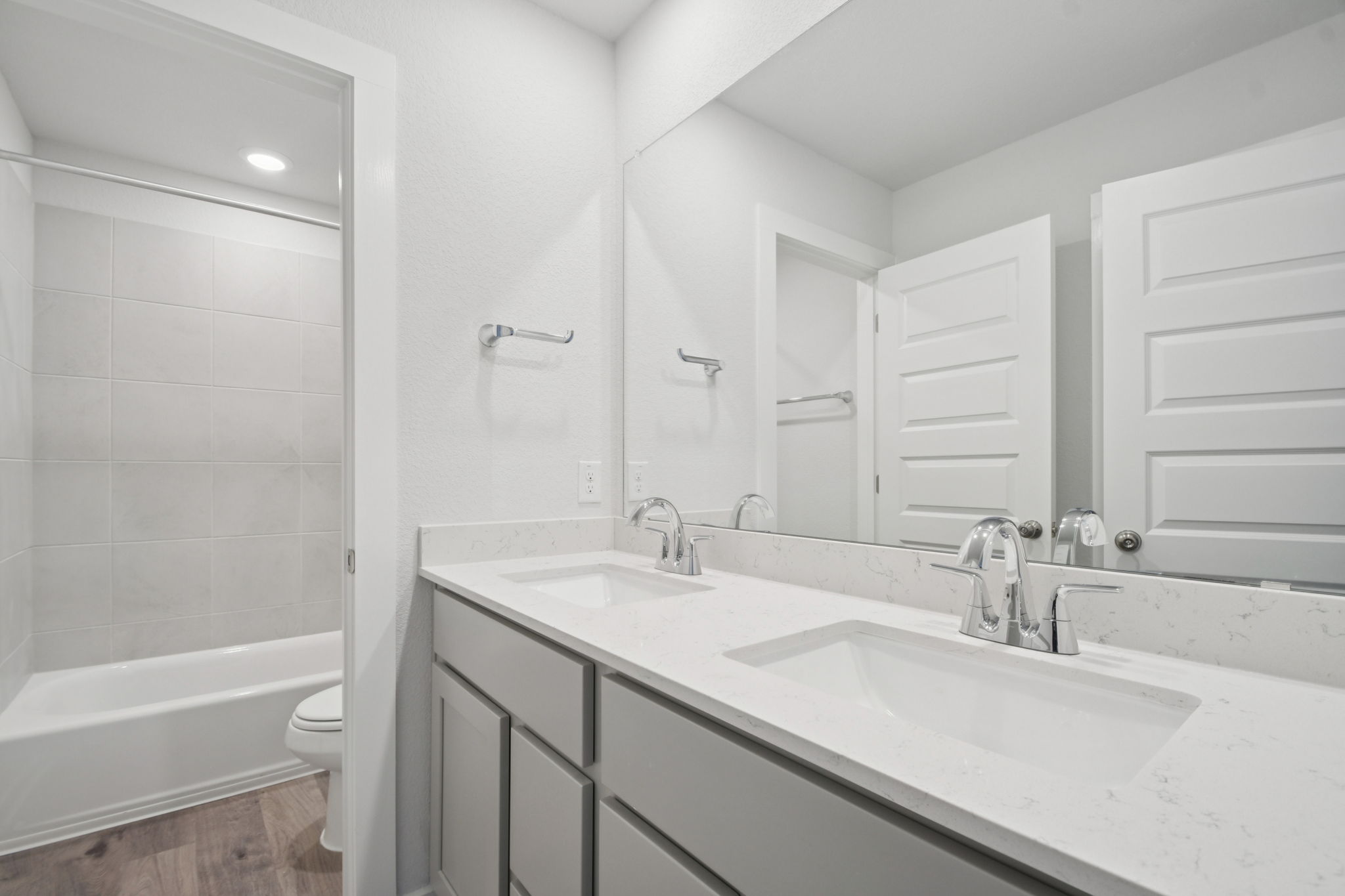 A bathroom with a tub sink and toilet.