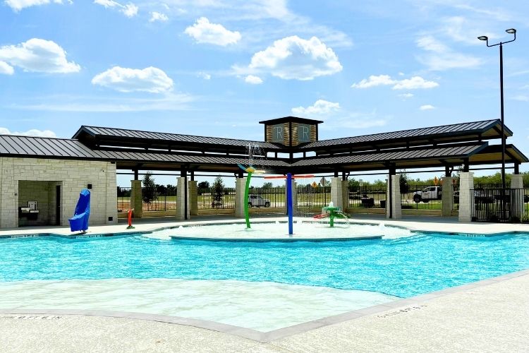 A swimming pool in front of a building.