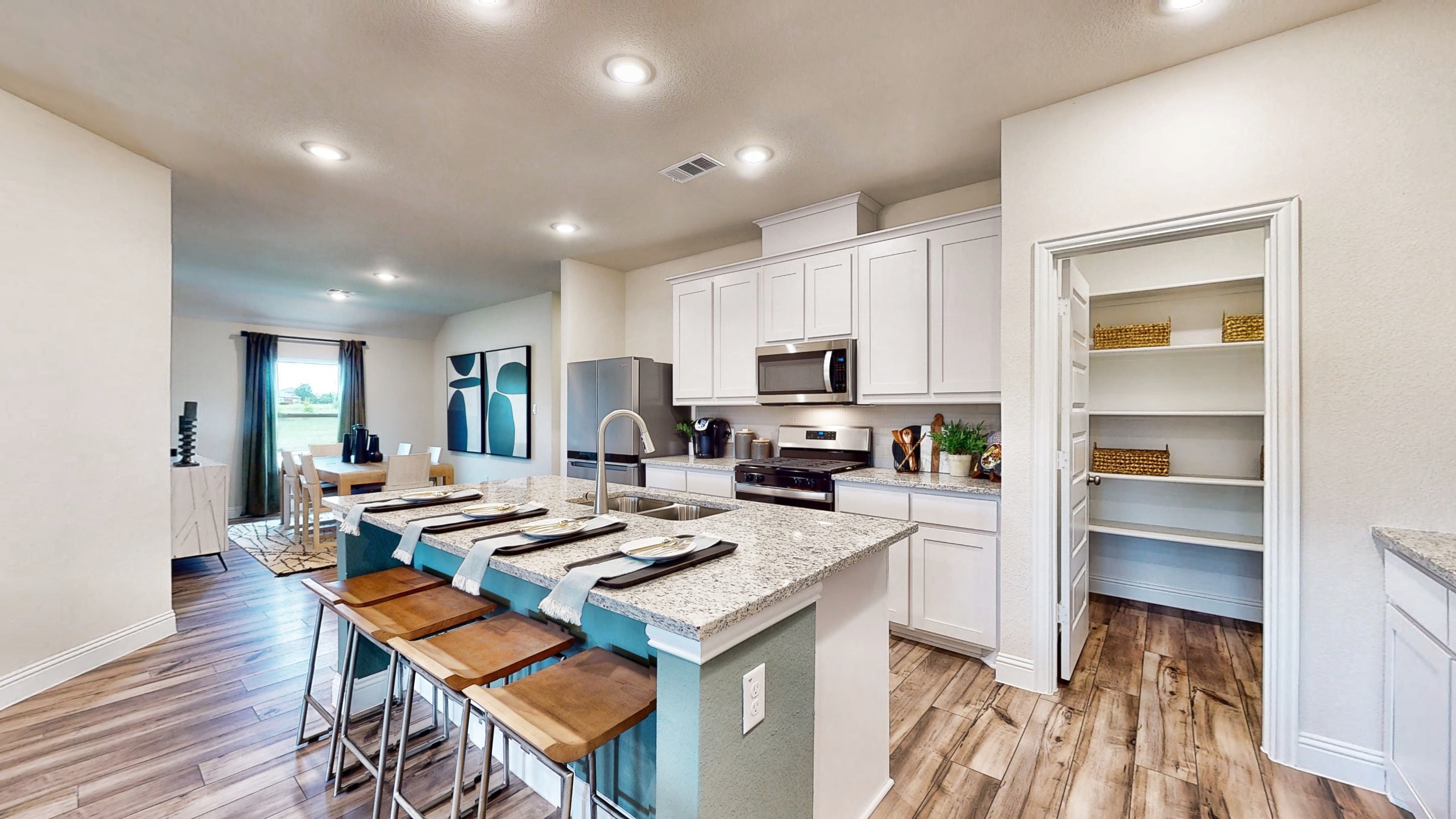 A kitchen with white cabinets.