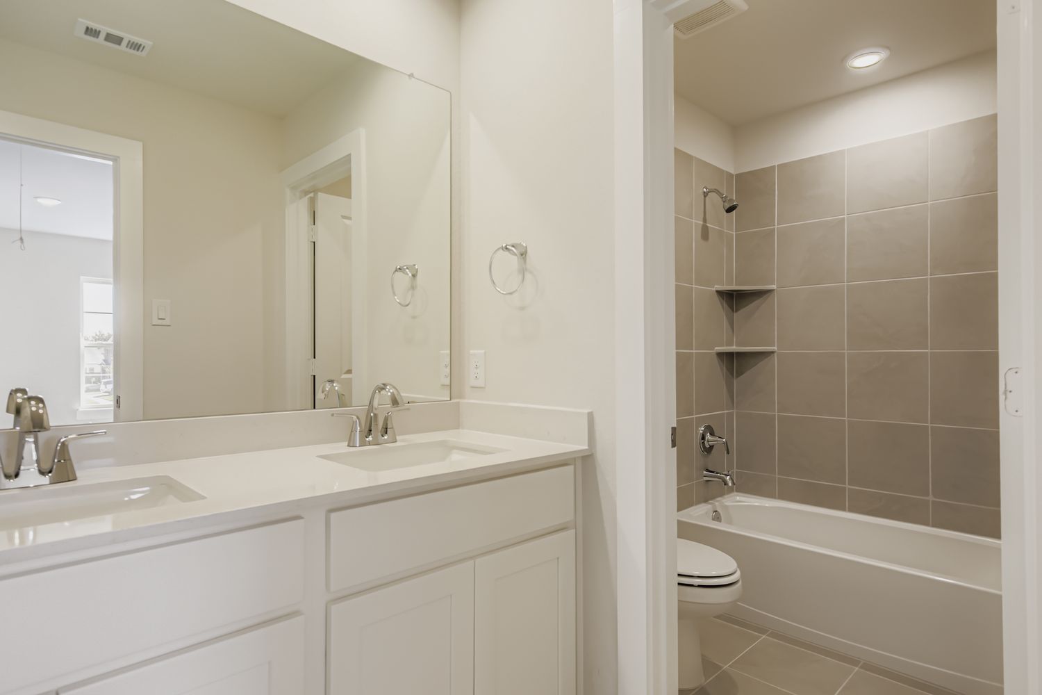 A bathroom with a tub sink and toilet.