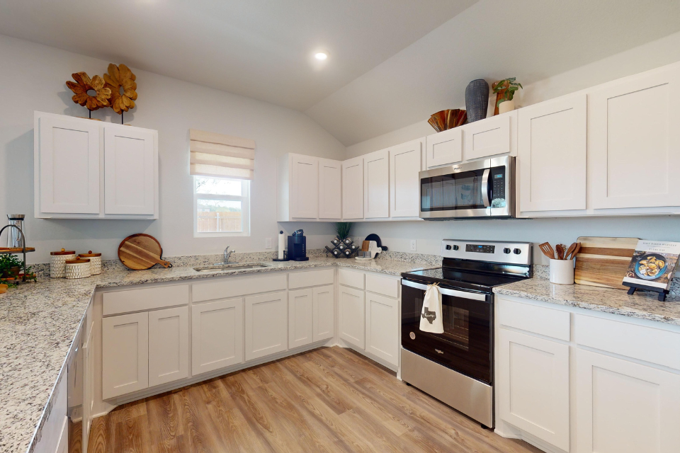A kitchen with white cabinets.