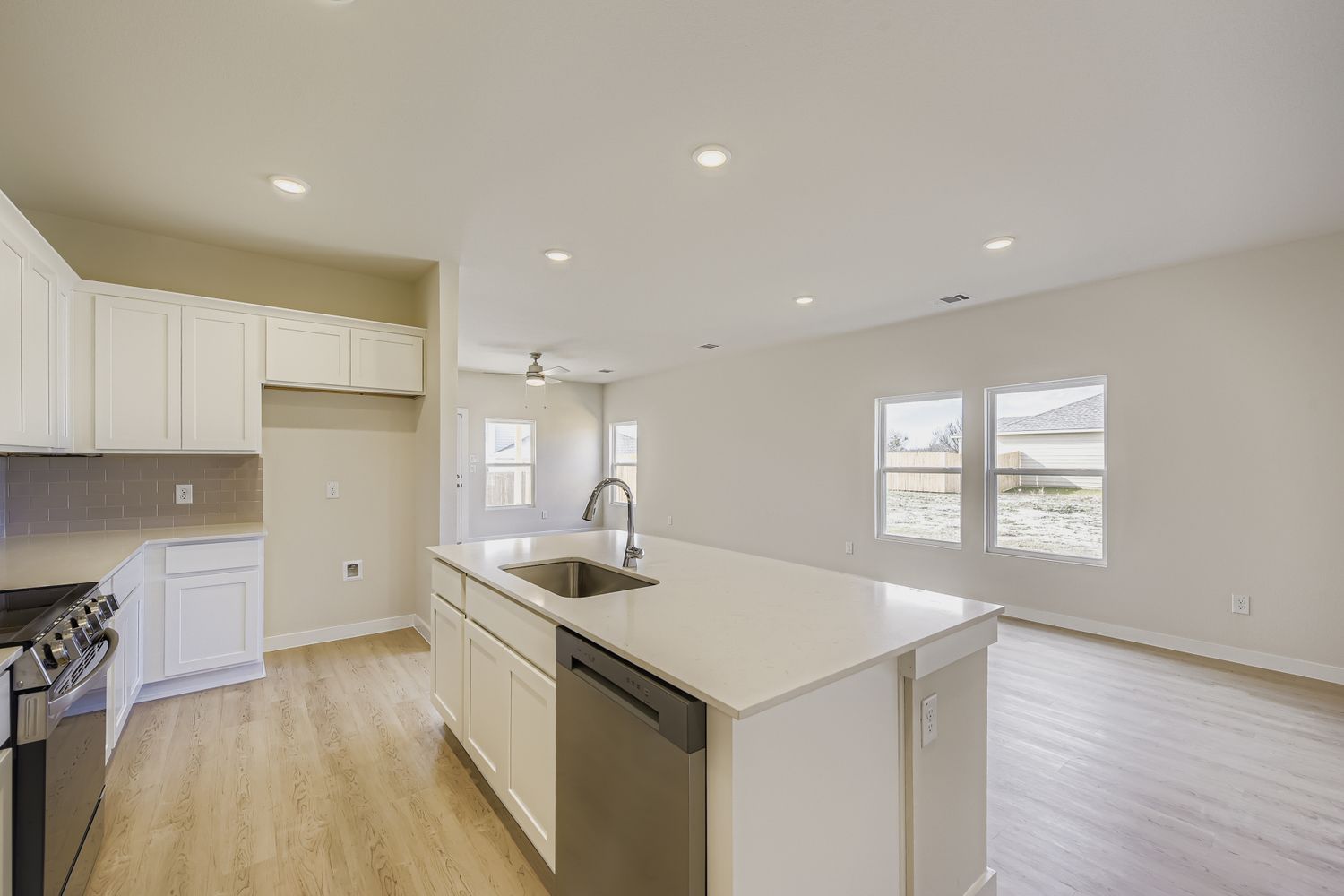 A kitchen with white cabinets.