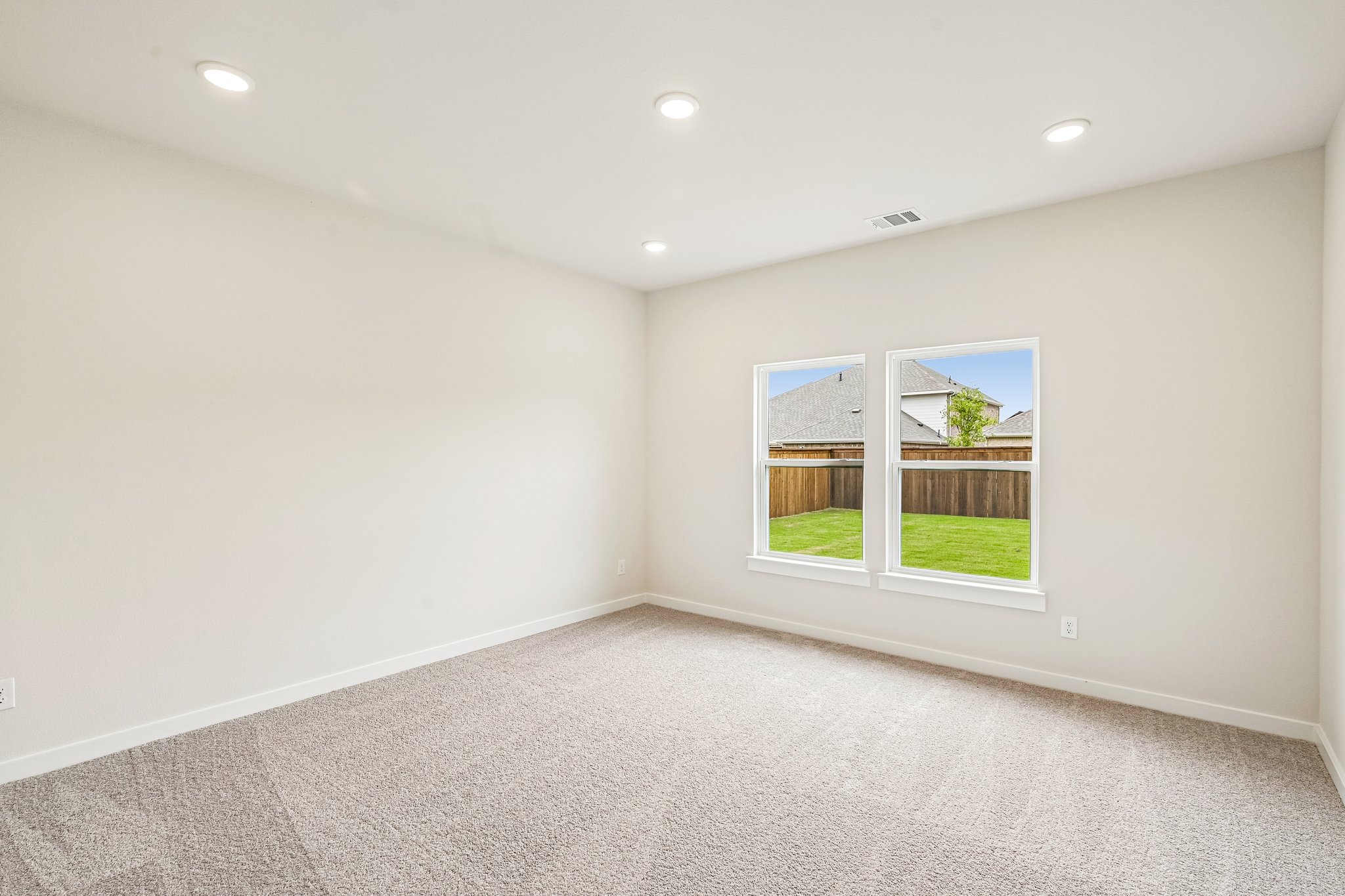 A room with a window and a plant in it.