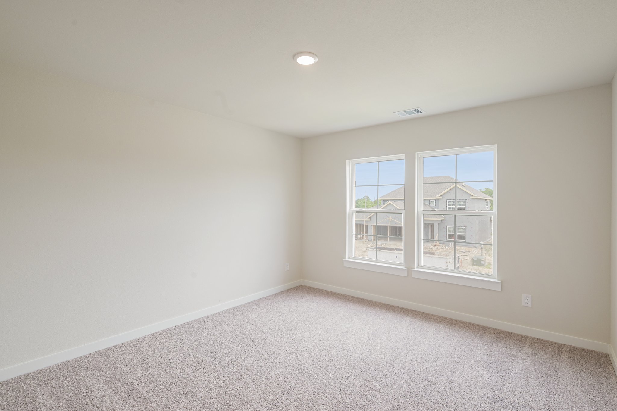 A room with a window and a carpet.