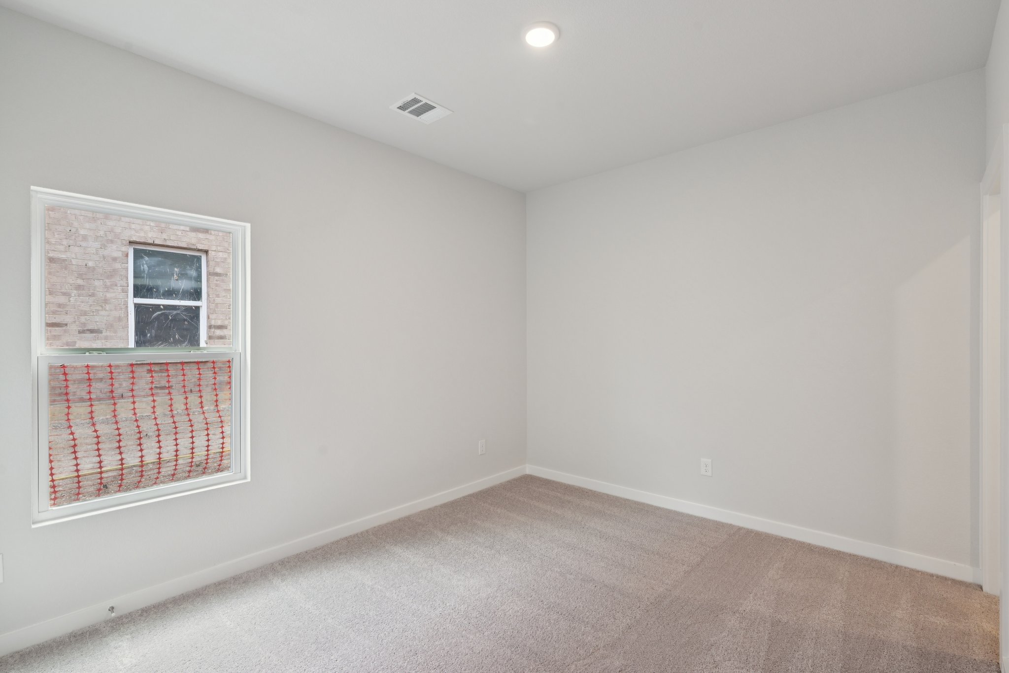 A room with a window and a door.