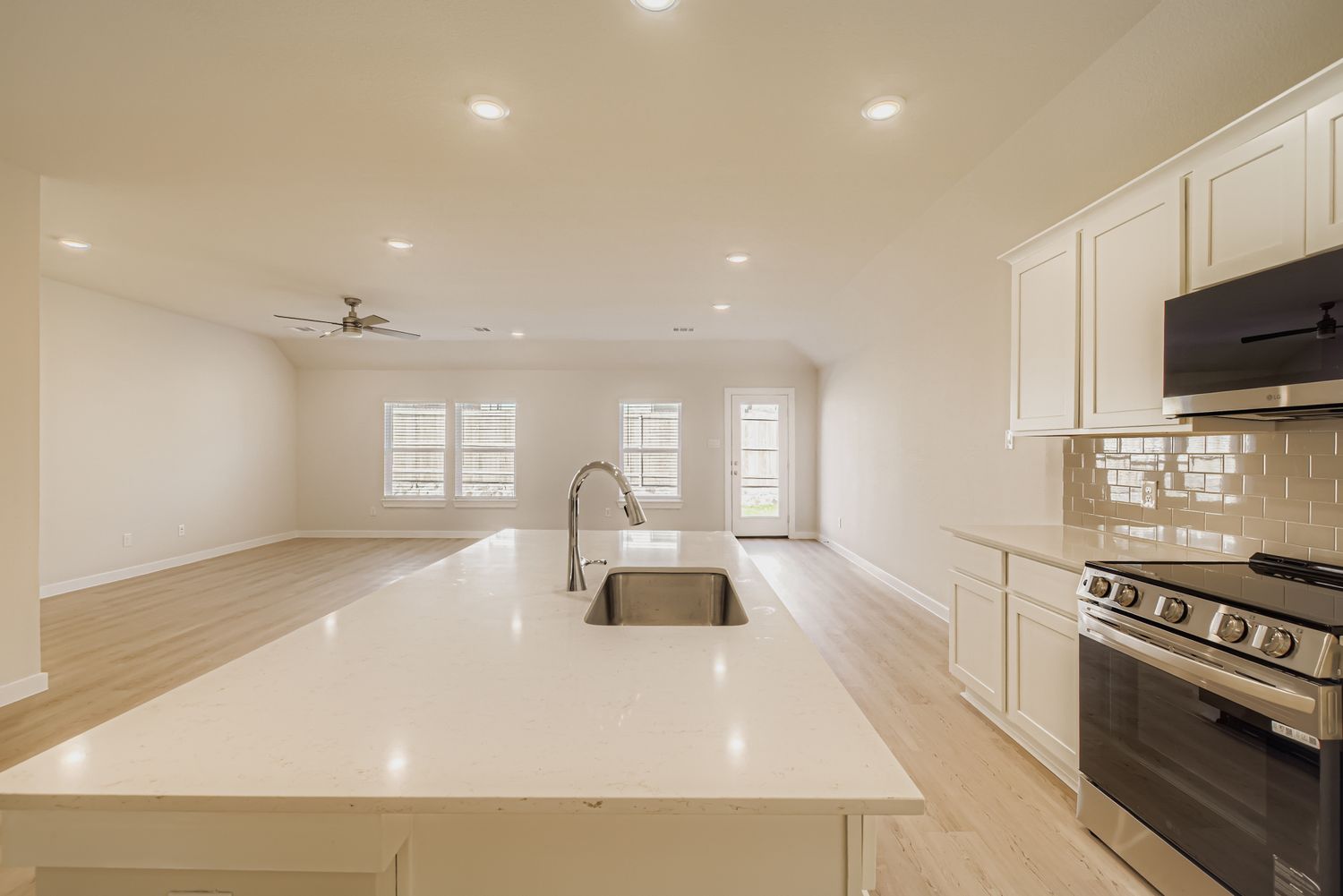 A kitchen with white cabinets.