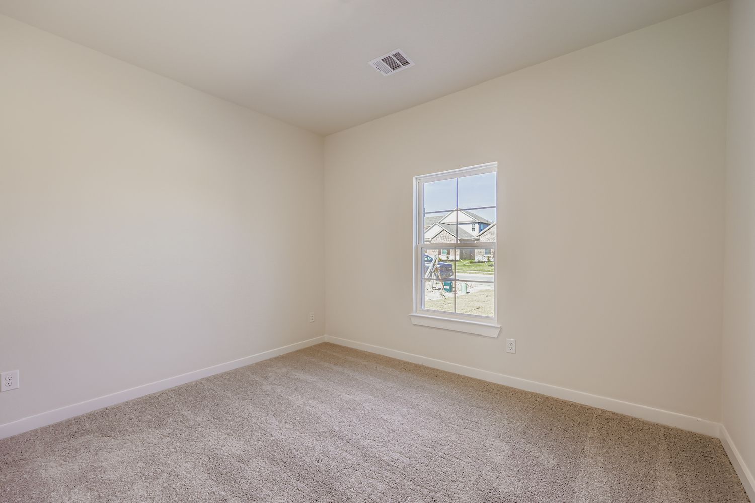 A room with a window and carpet.