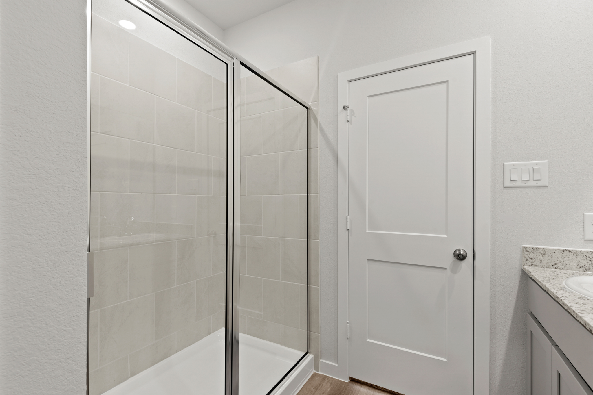 A bathroom with a glass shower.