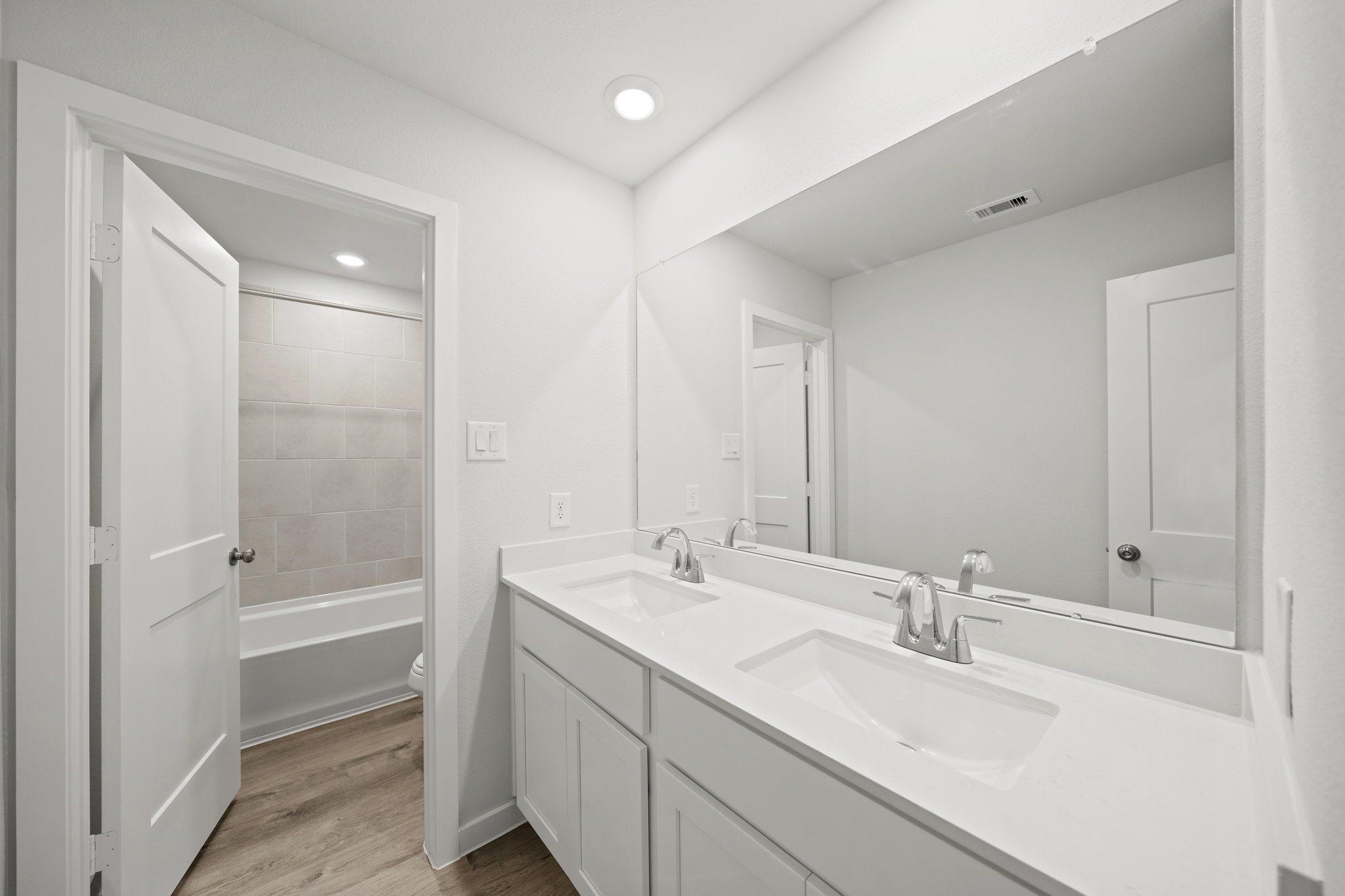 A bathroom with a large mirror.