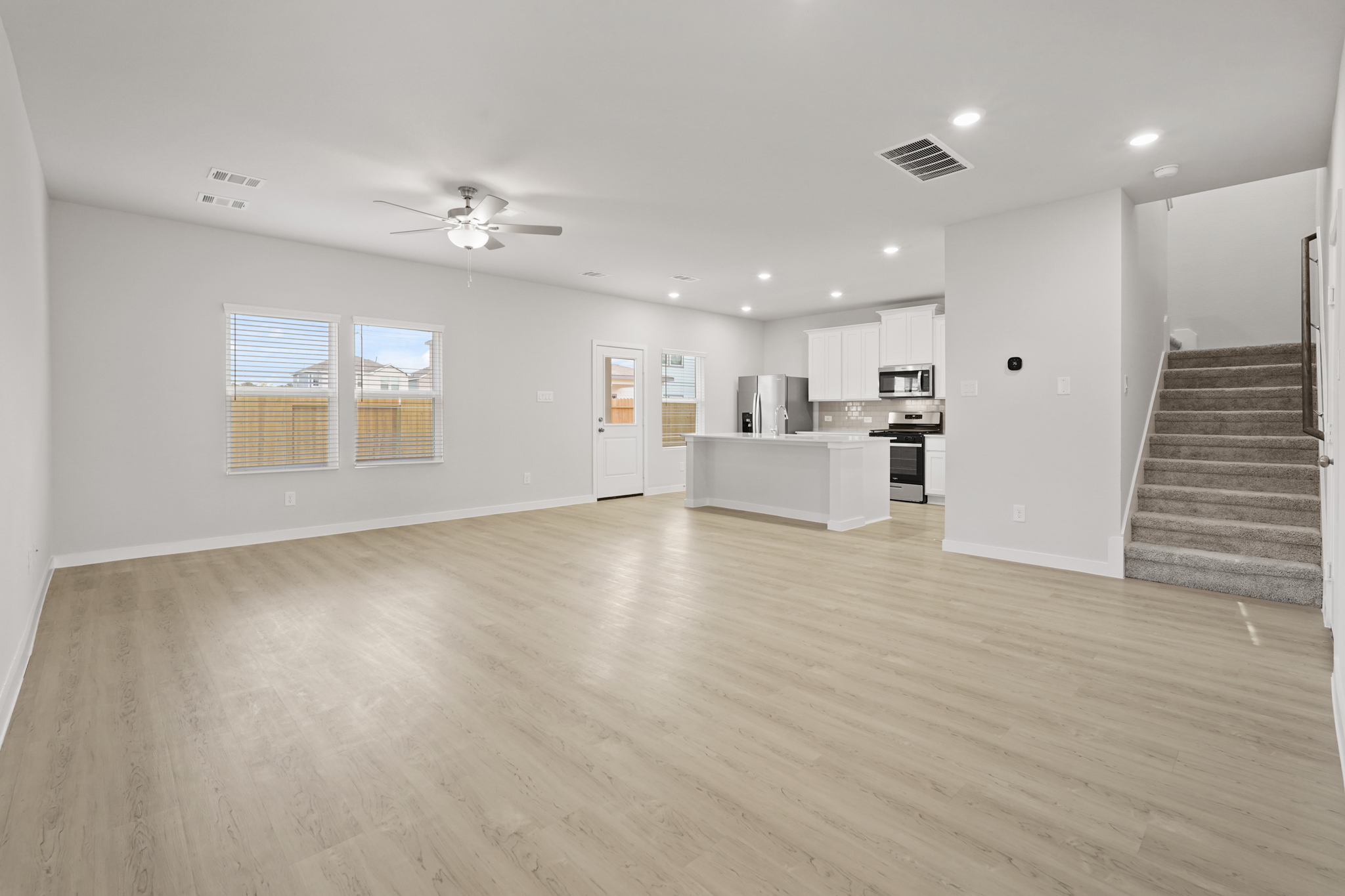 A large kitchen with a wood floor.