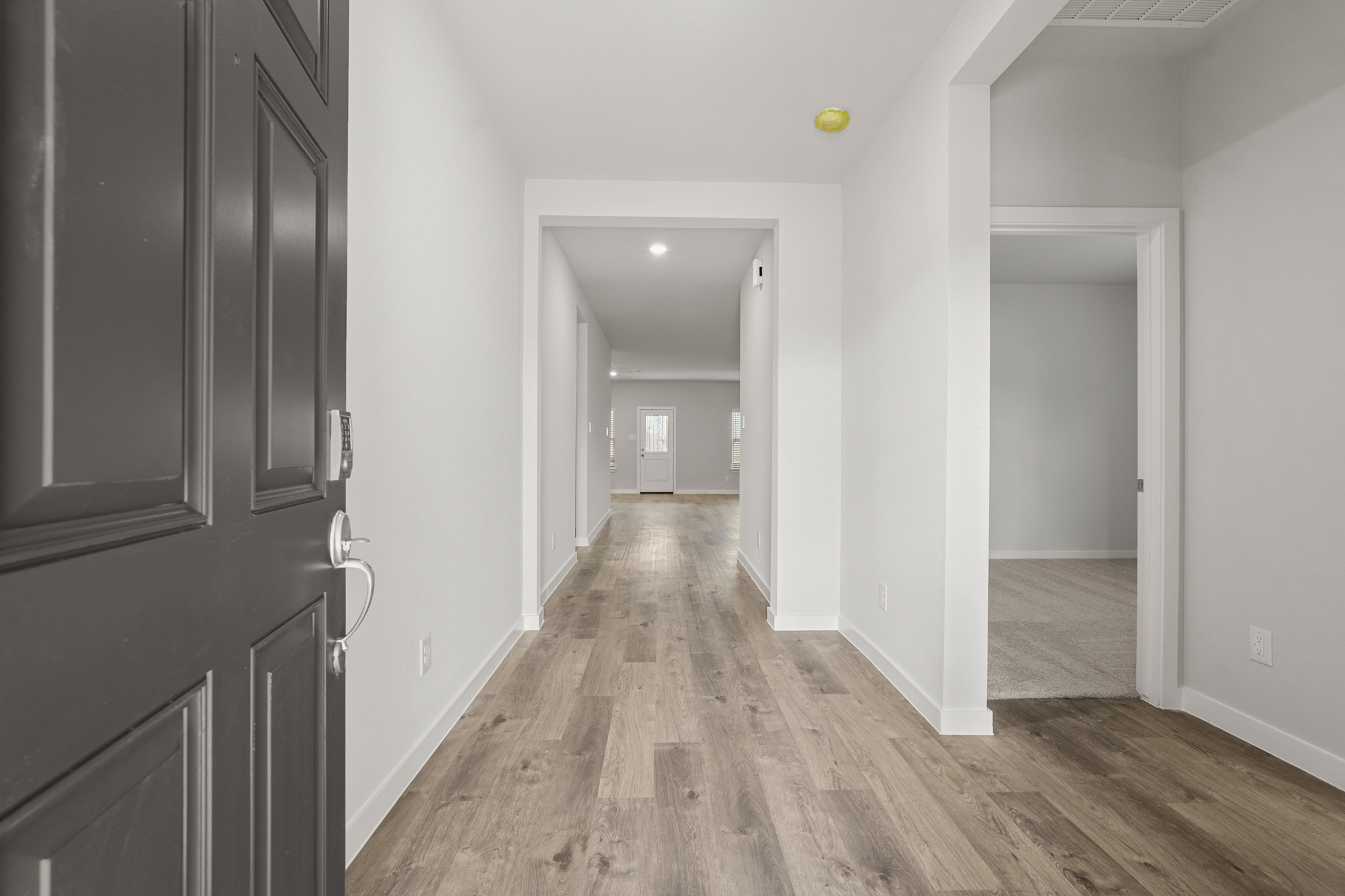 A hallway with wooden floors.