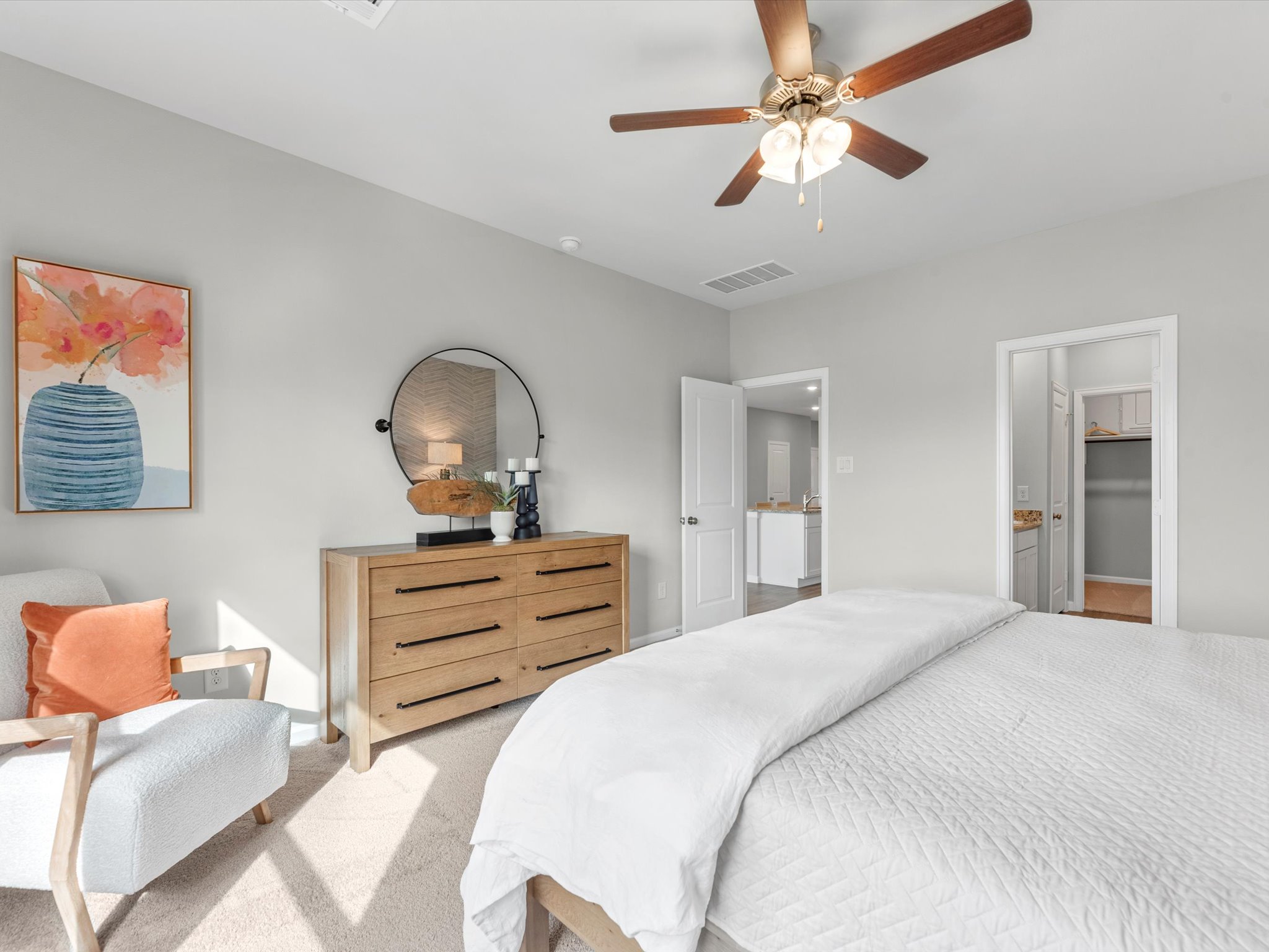 A bedroom with a bed and a fan.