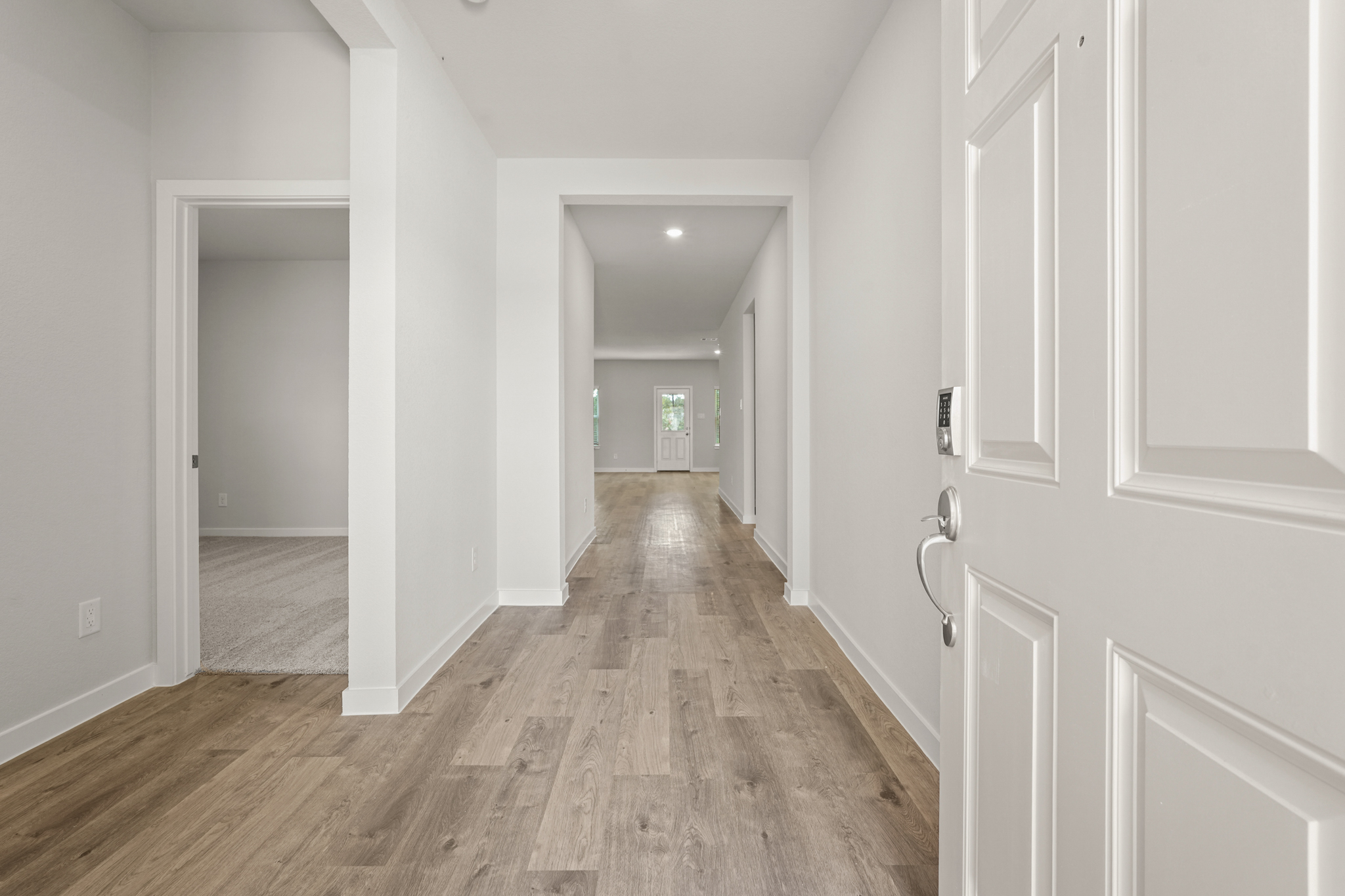 A hallway with white doors.