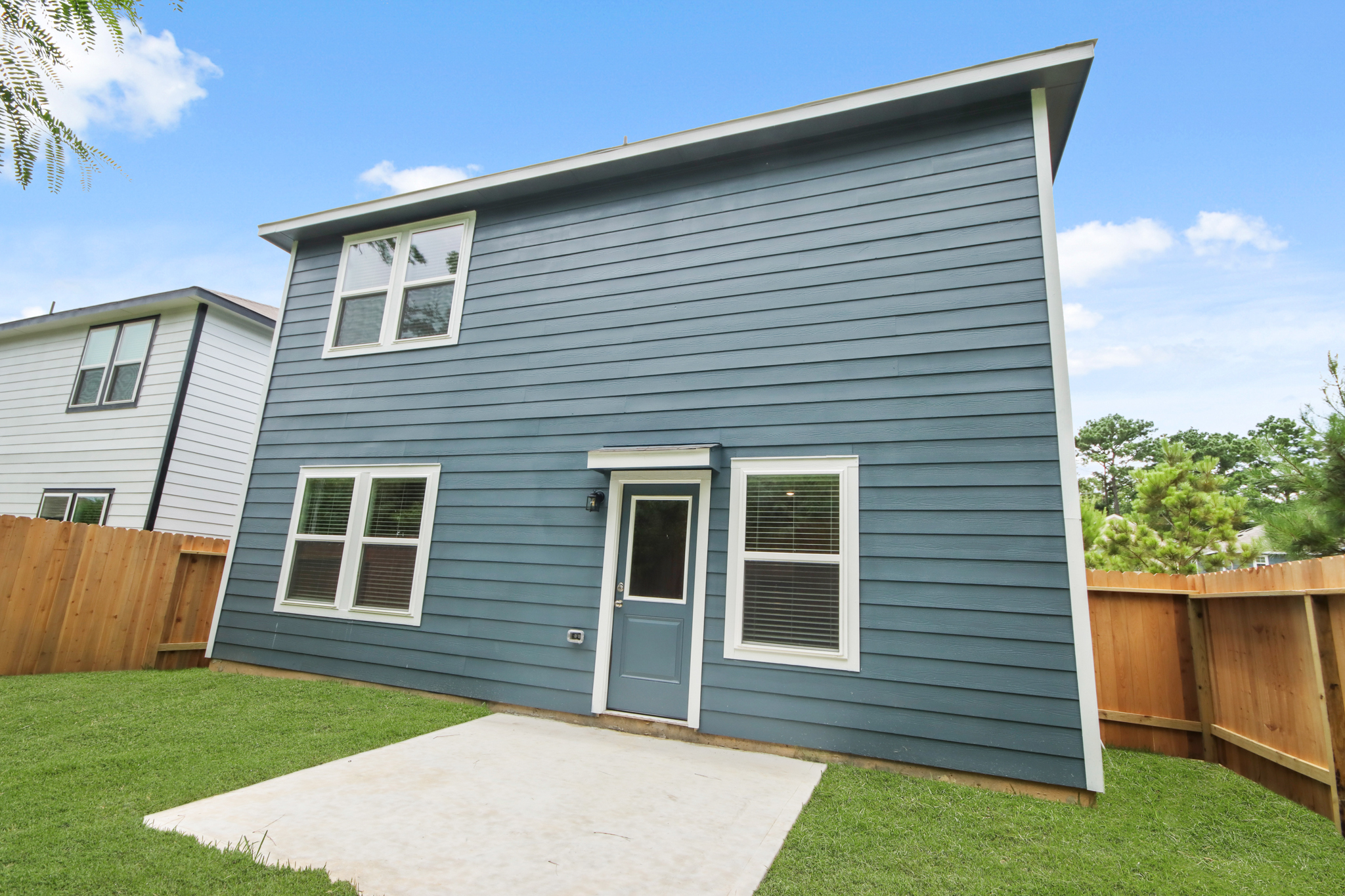 A house with a fence and grass.