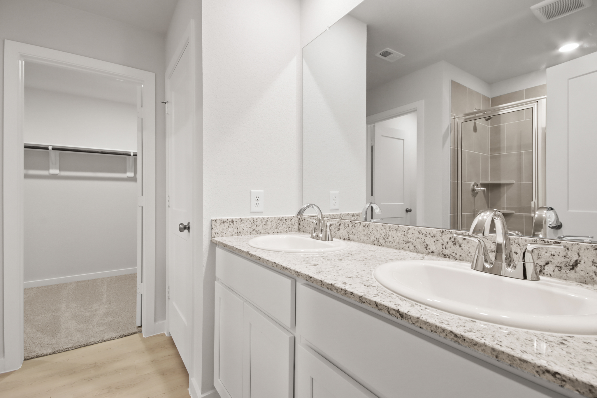 A bathroom with a large mirror.