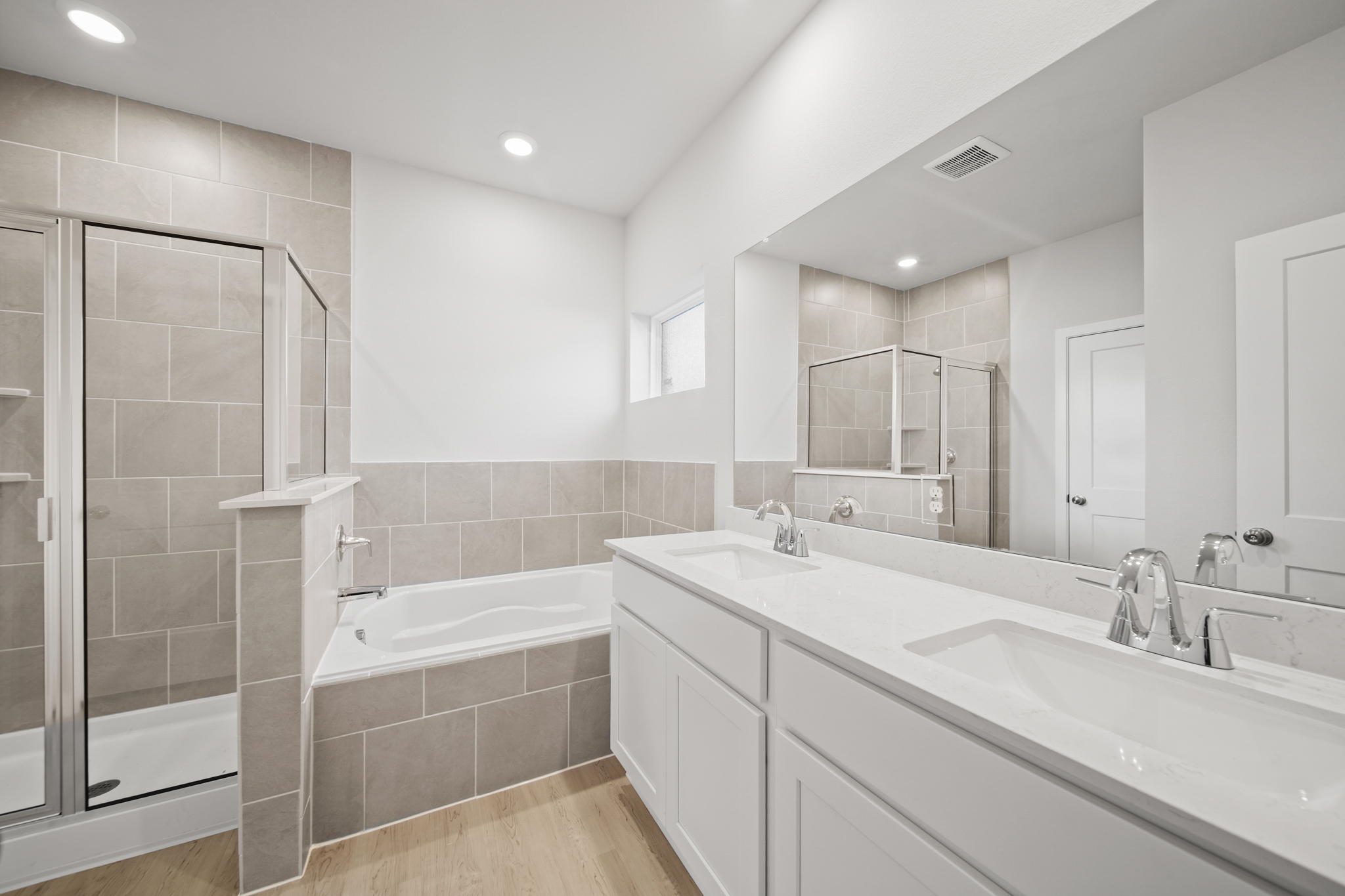 A bathroom with a tub sink and a shower.