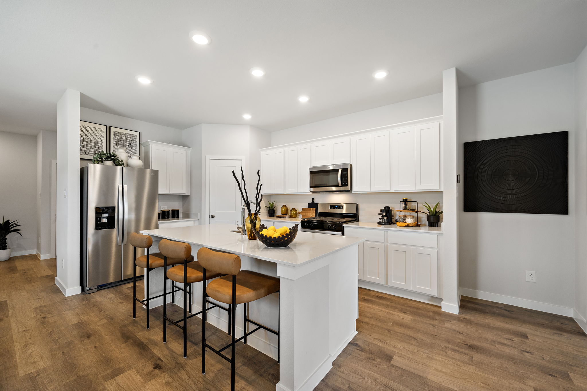 A kitchen with white cabinets.