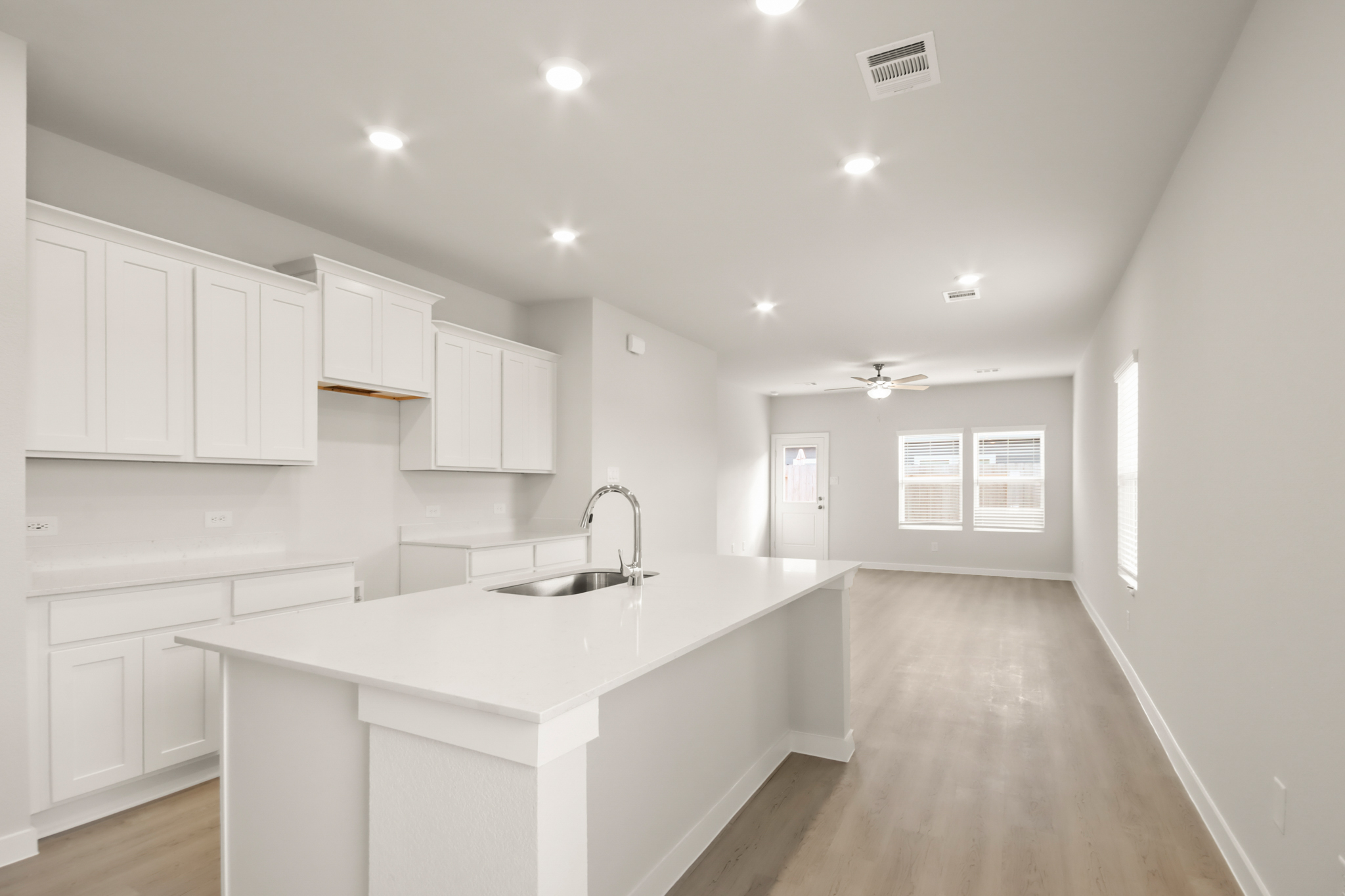 A kitchen with white cabinets.