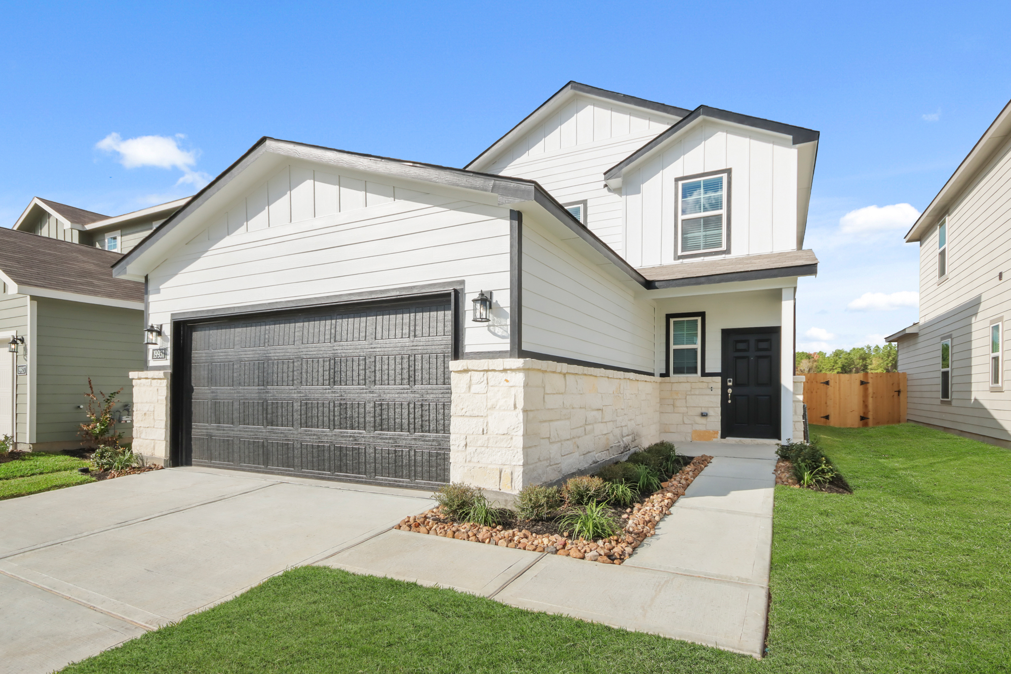 A white house with a garage.