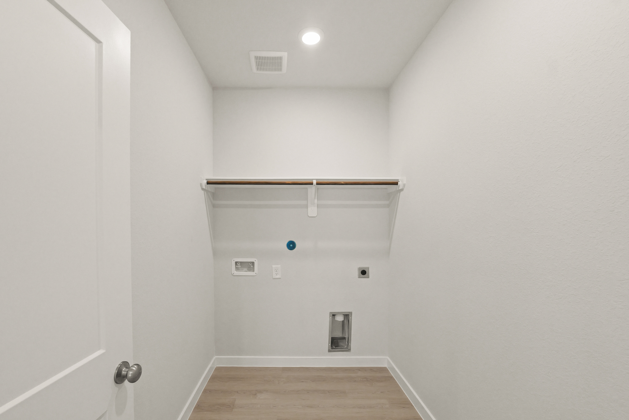 A room with a wood floor and white walls.