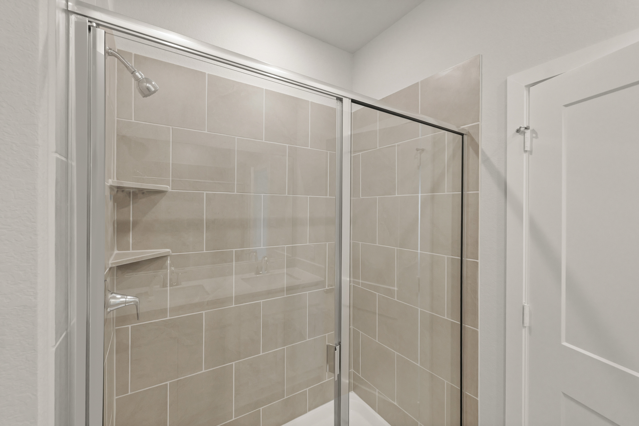 A shower with a glass door.