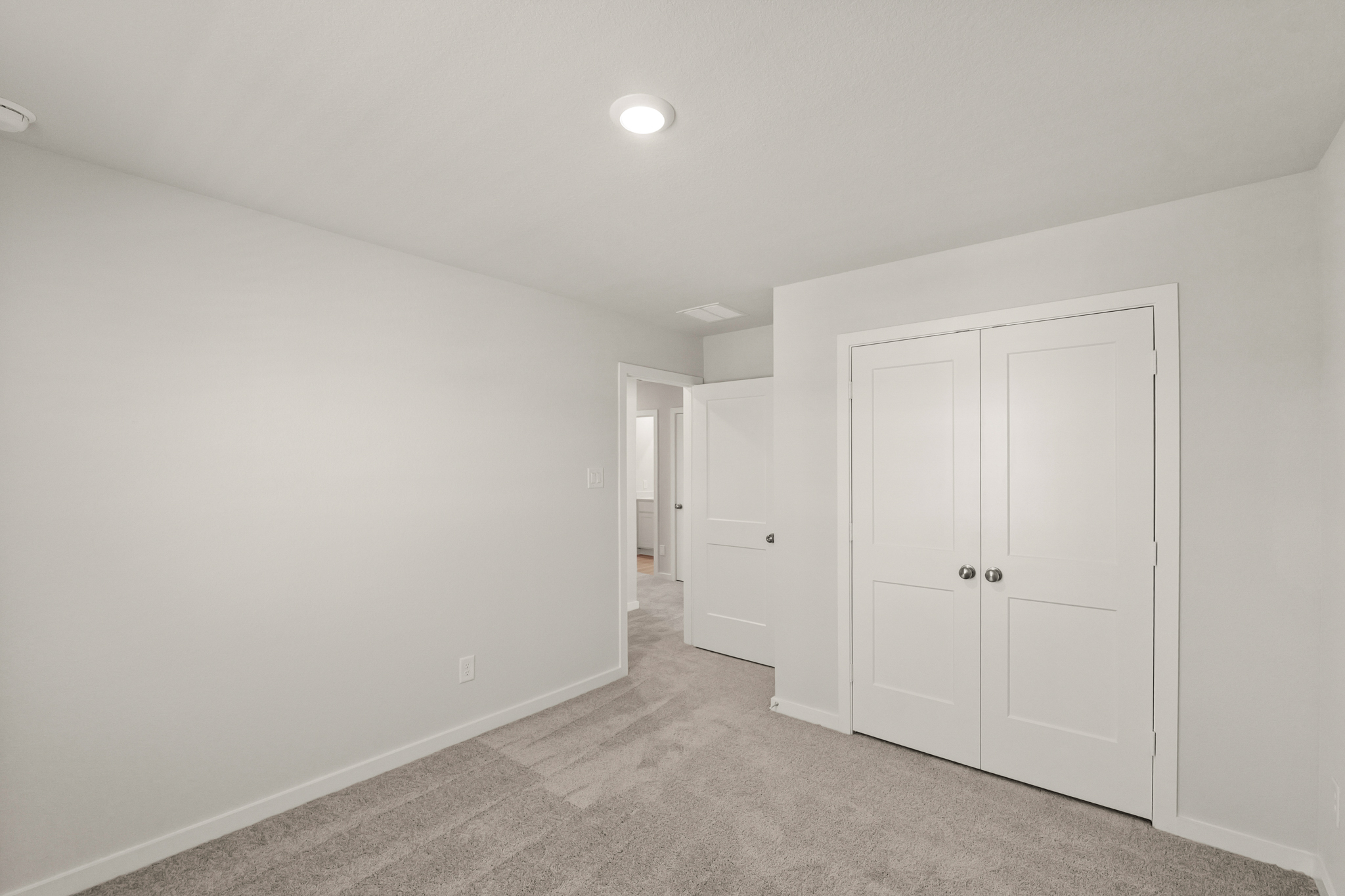 A hallway with white doors.