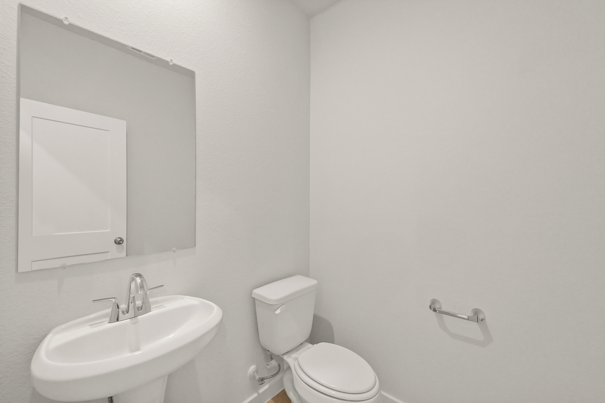 A bathroom with a toilet and sink.