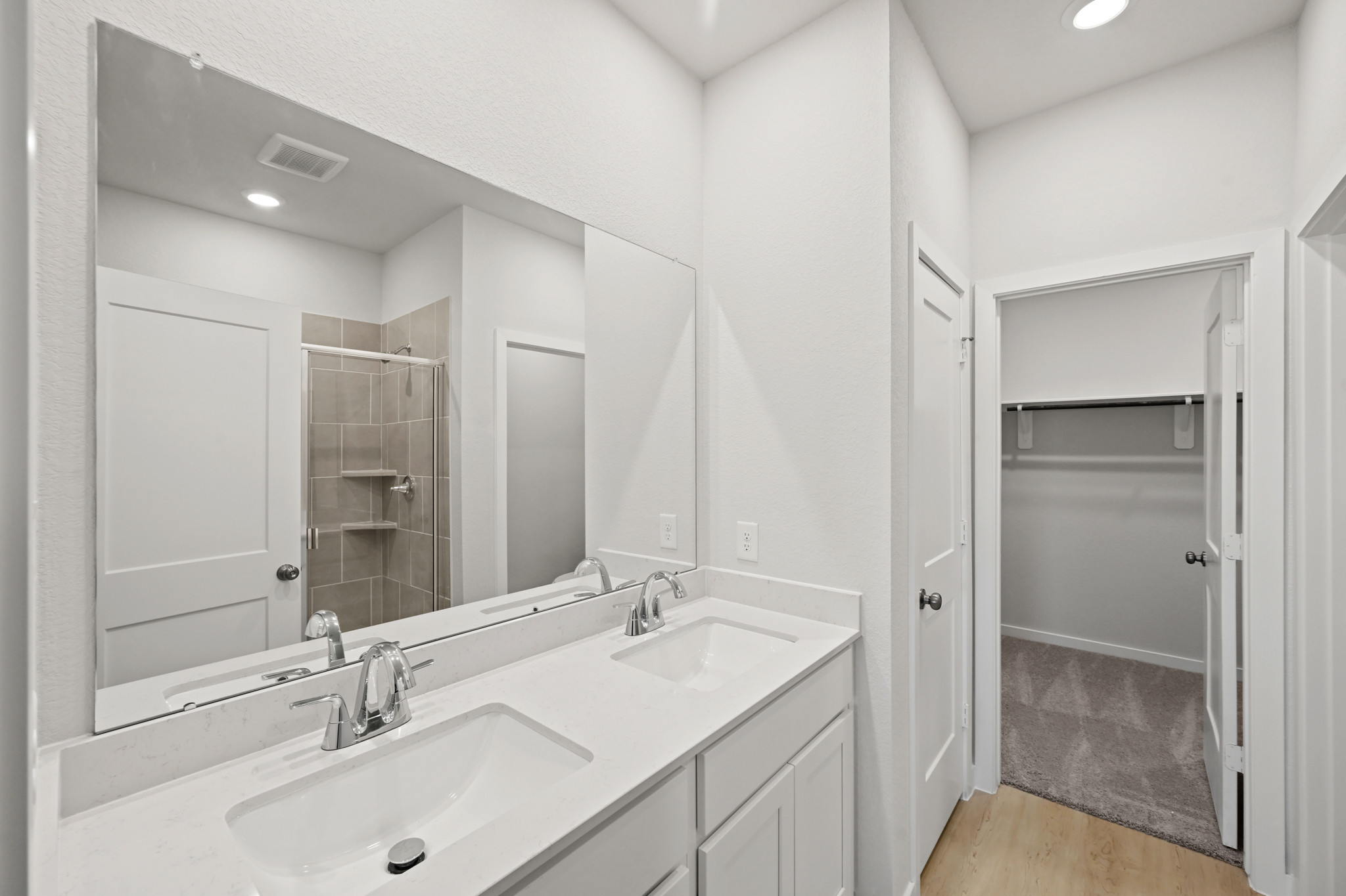 A bathroom with a large mirror.