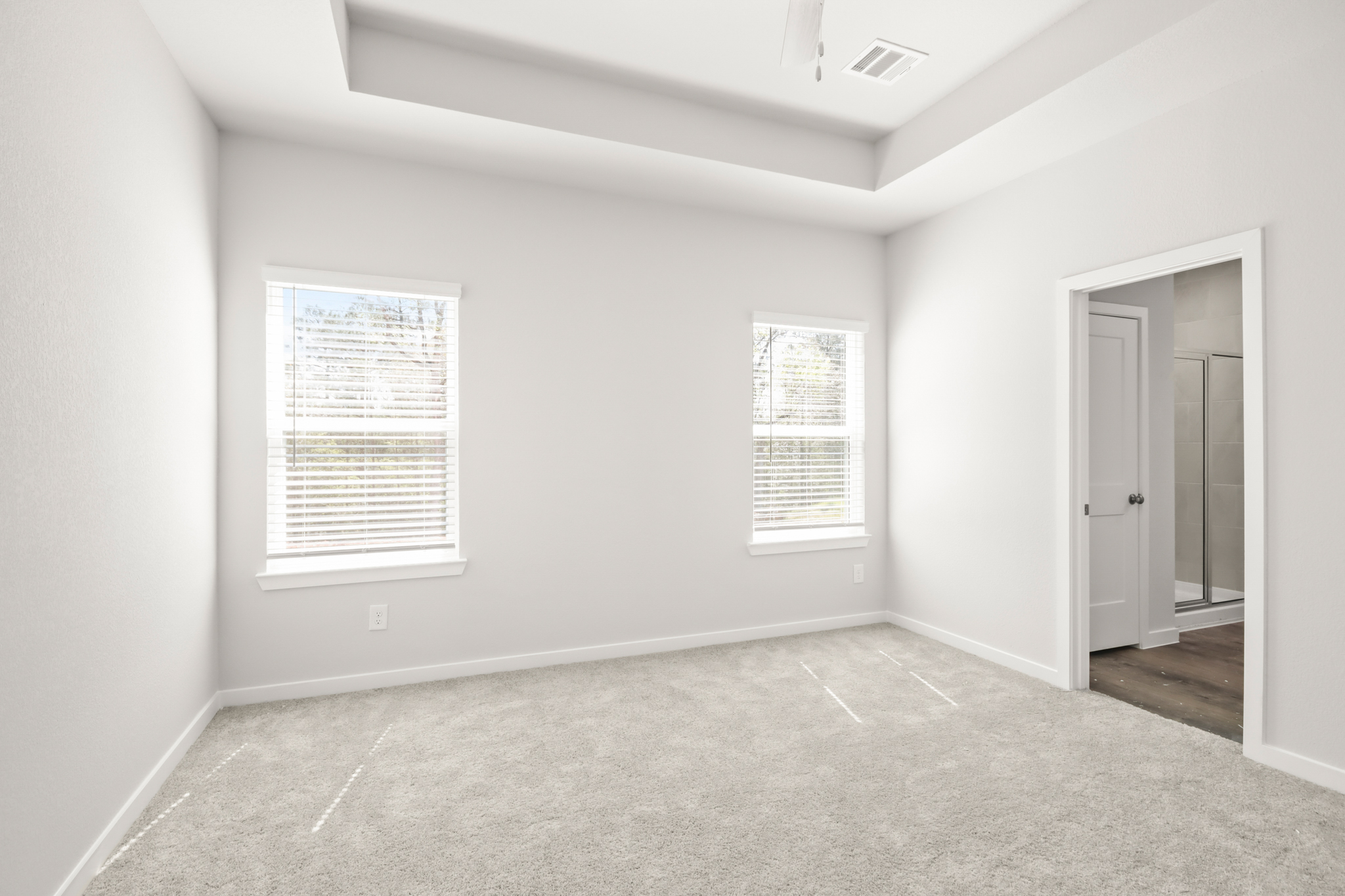 A hallway with a door and a window.