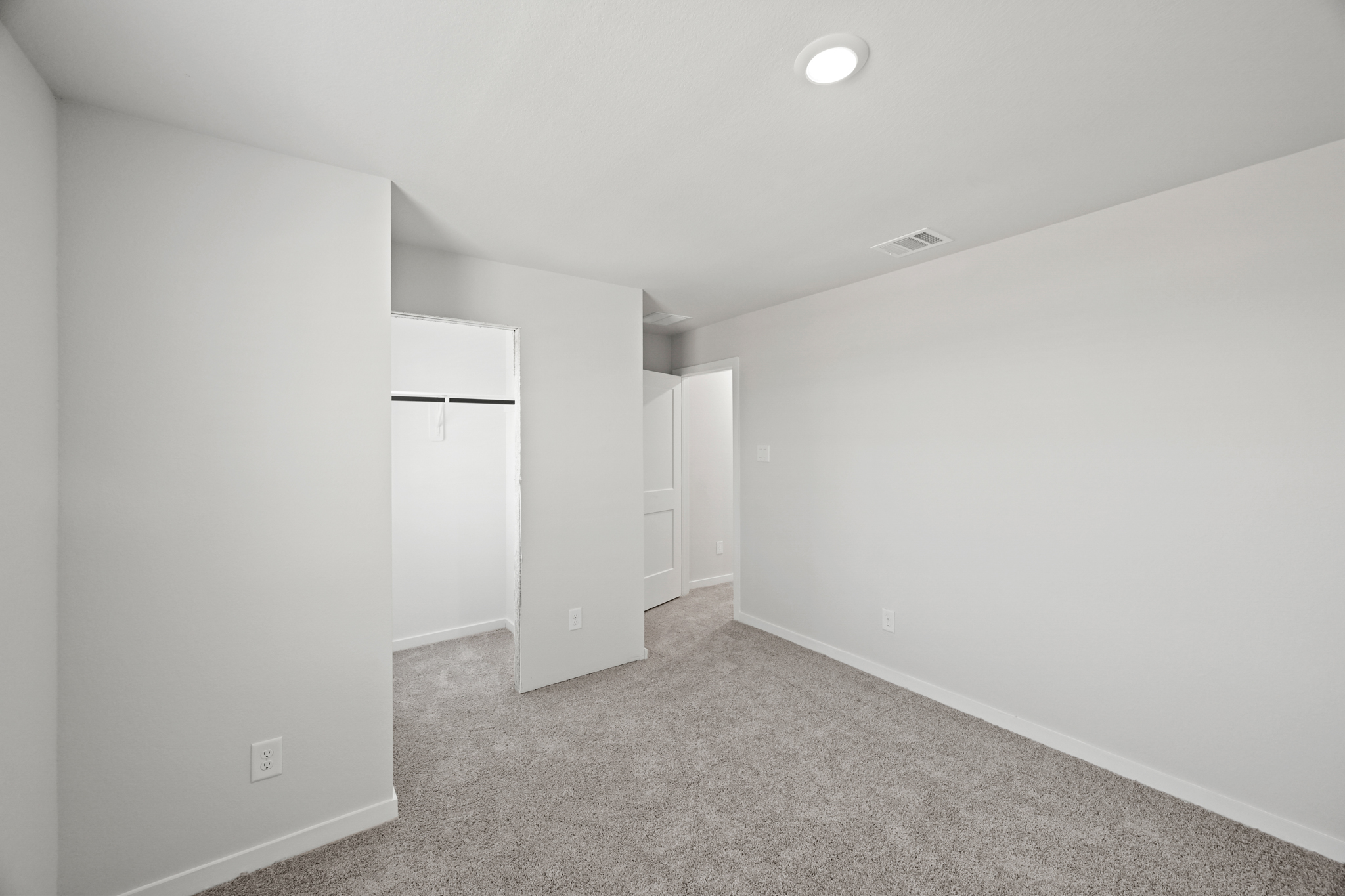 A hallway with white walls.