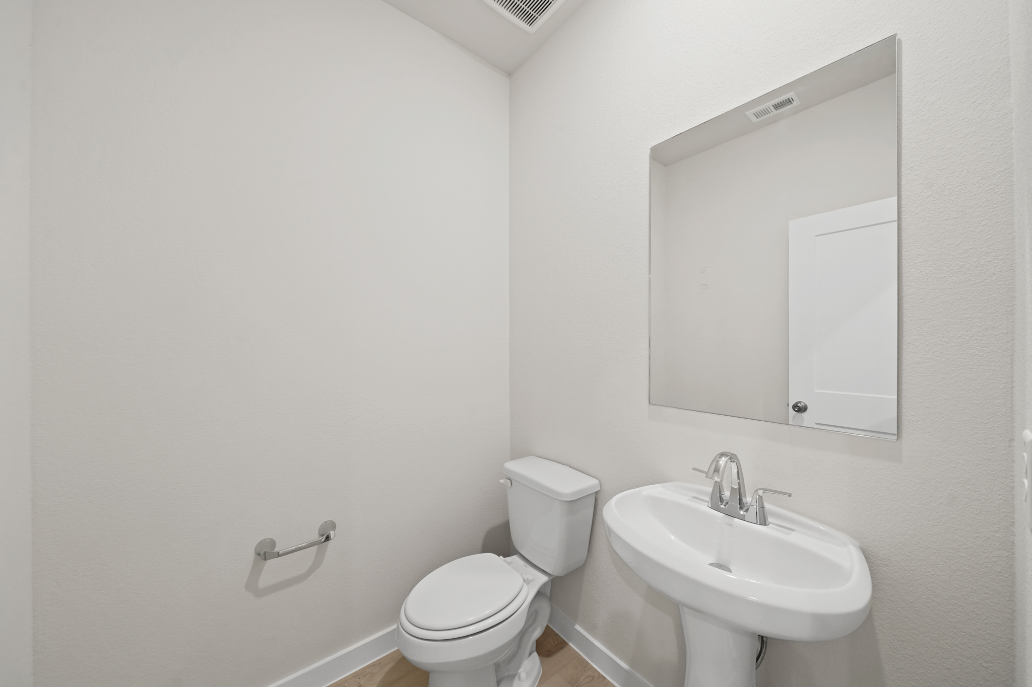 A bathroom with a toilet and sink.