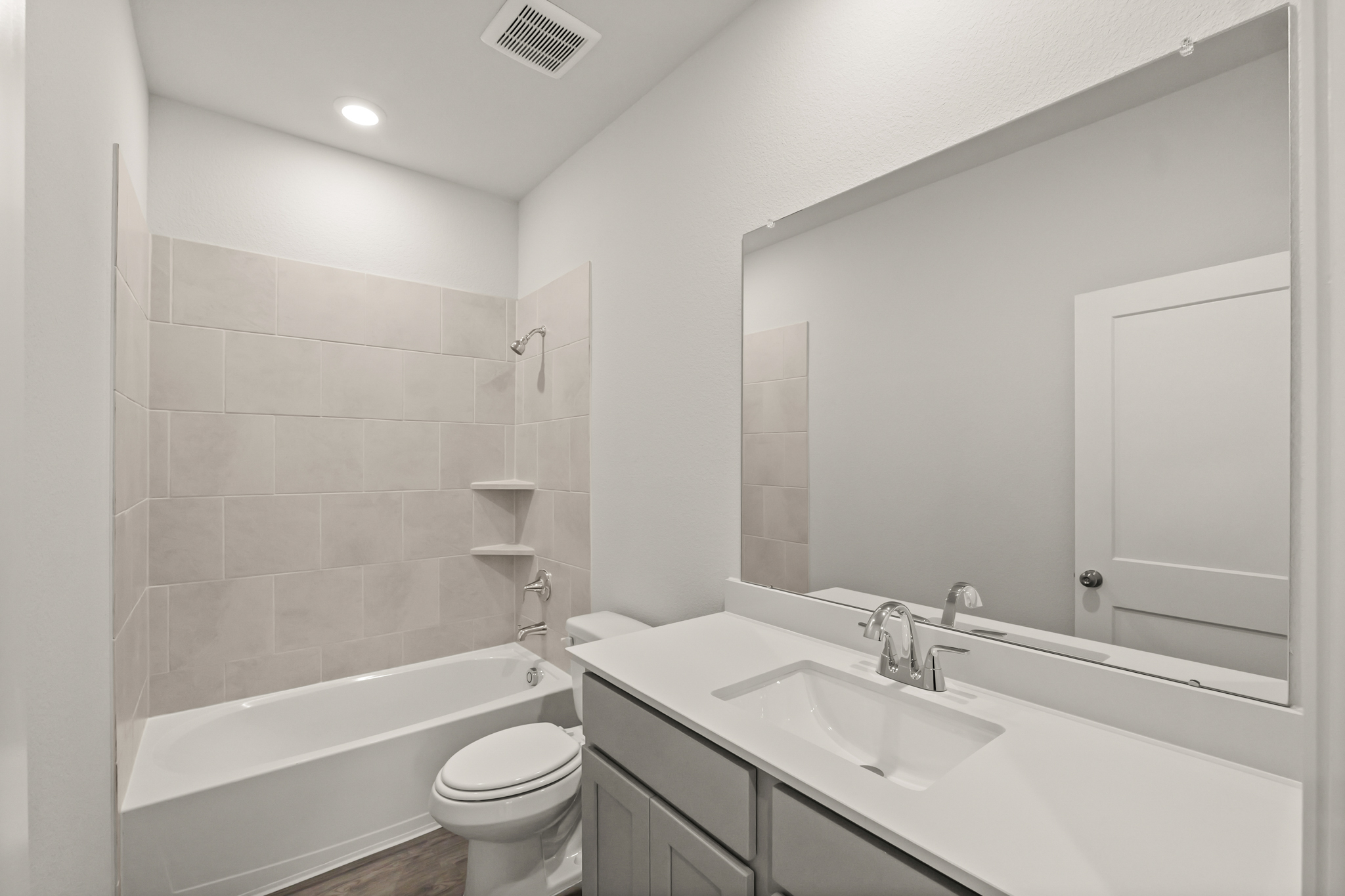 A bathroom with a tub sink and toilet.