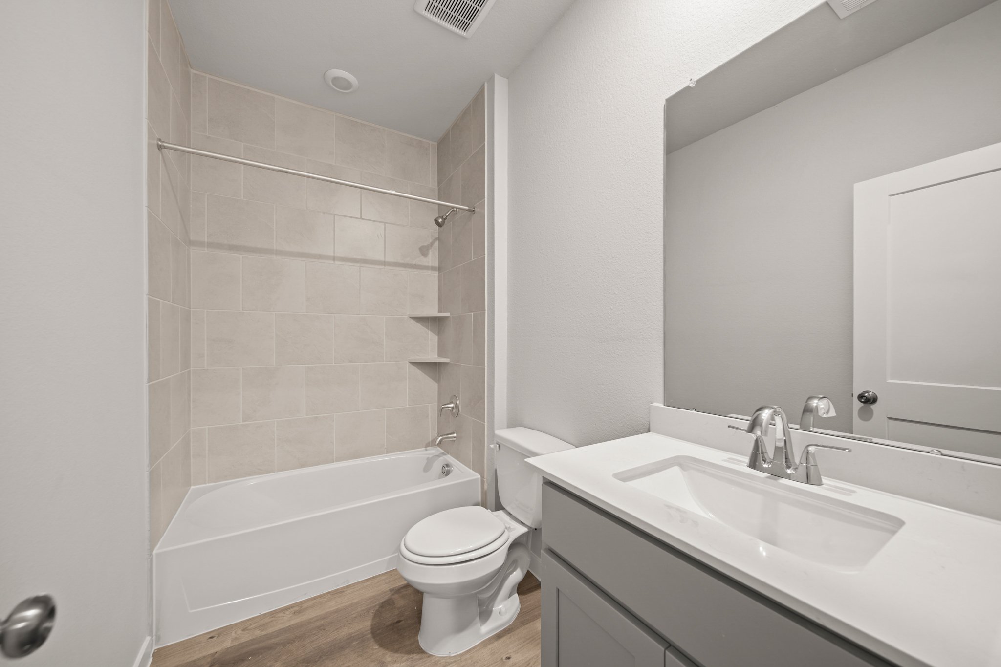 A bathroom with a tub sink and toilet.