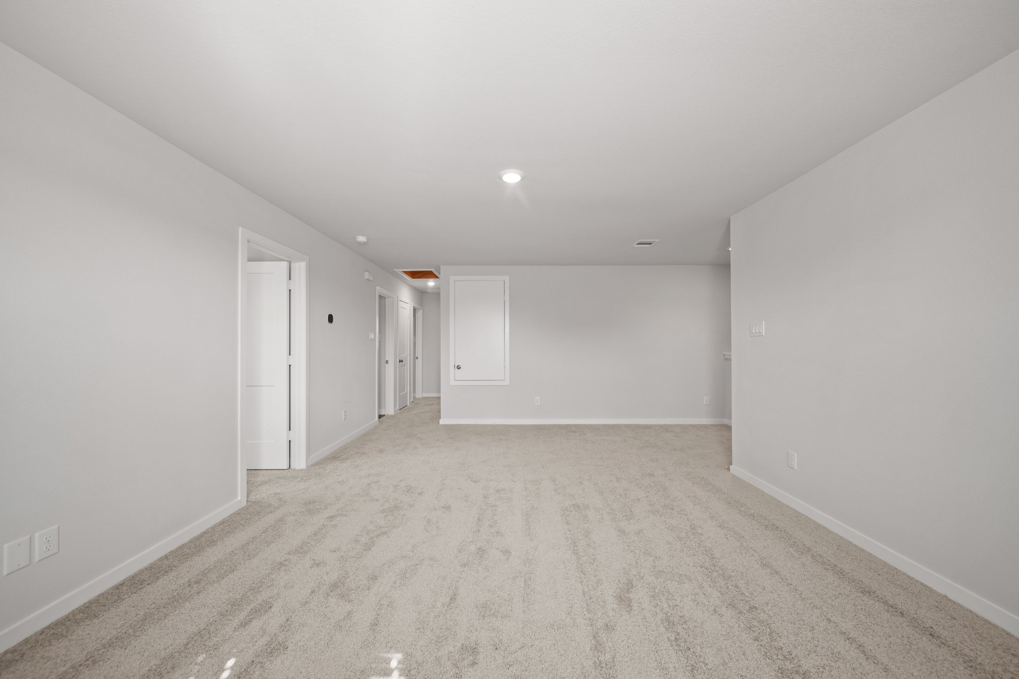 A long hallway with white walls.