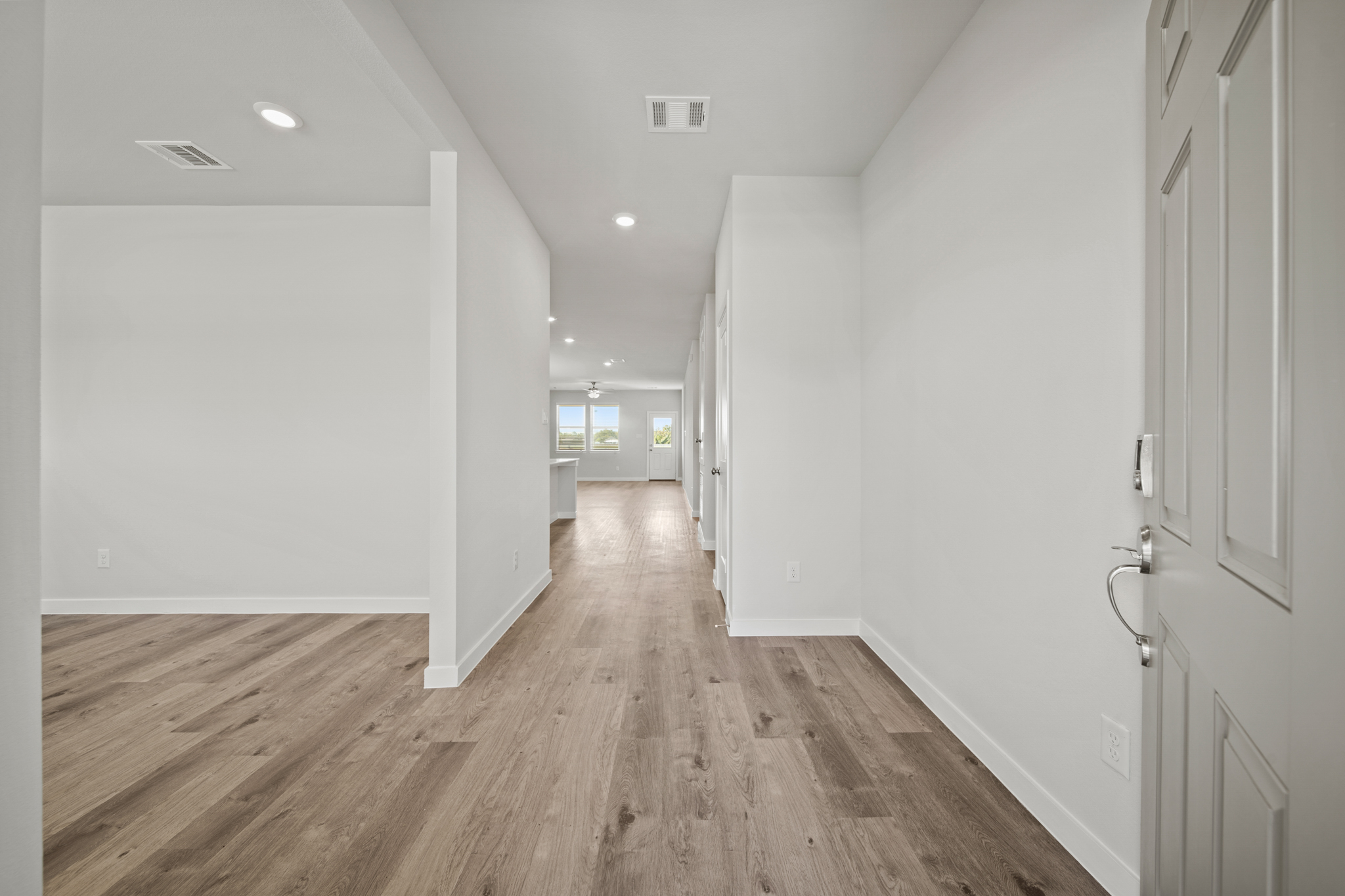 A hallway with white walls.