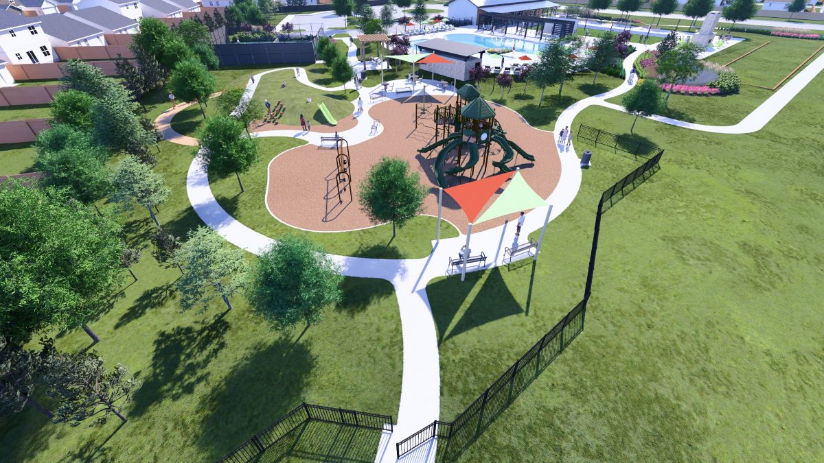 A large green lawn with a building and trees.