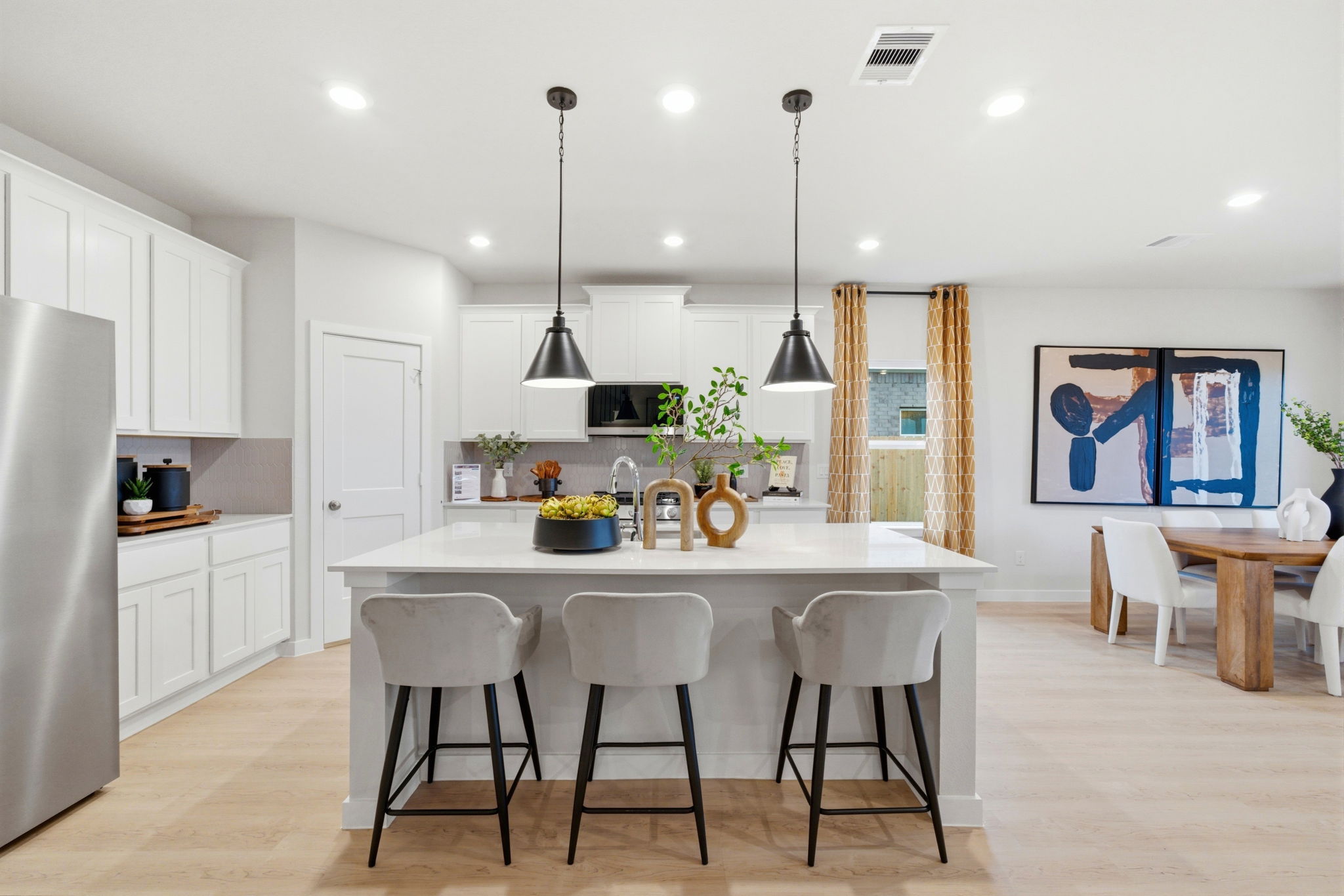 A kitchen with white cabinets.