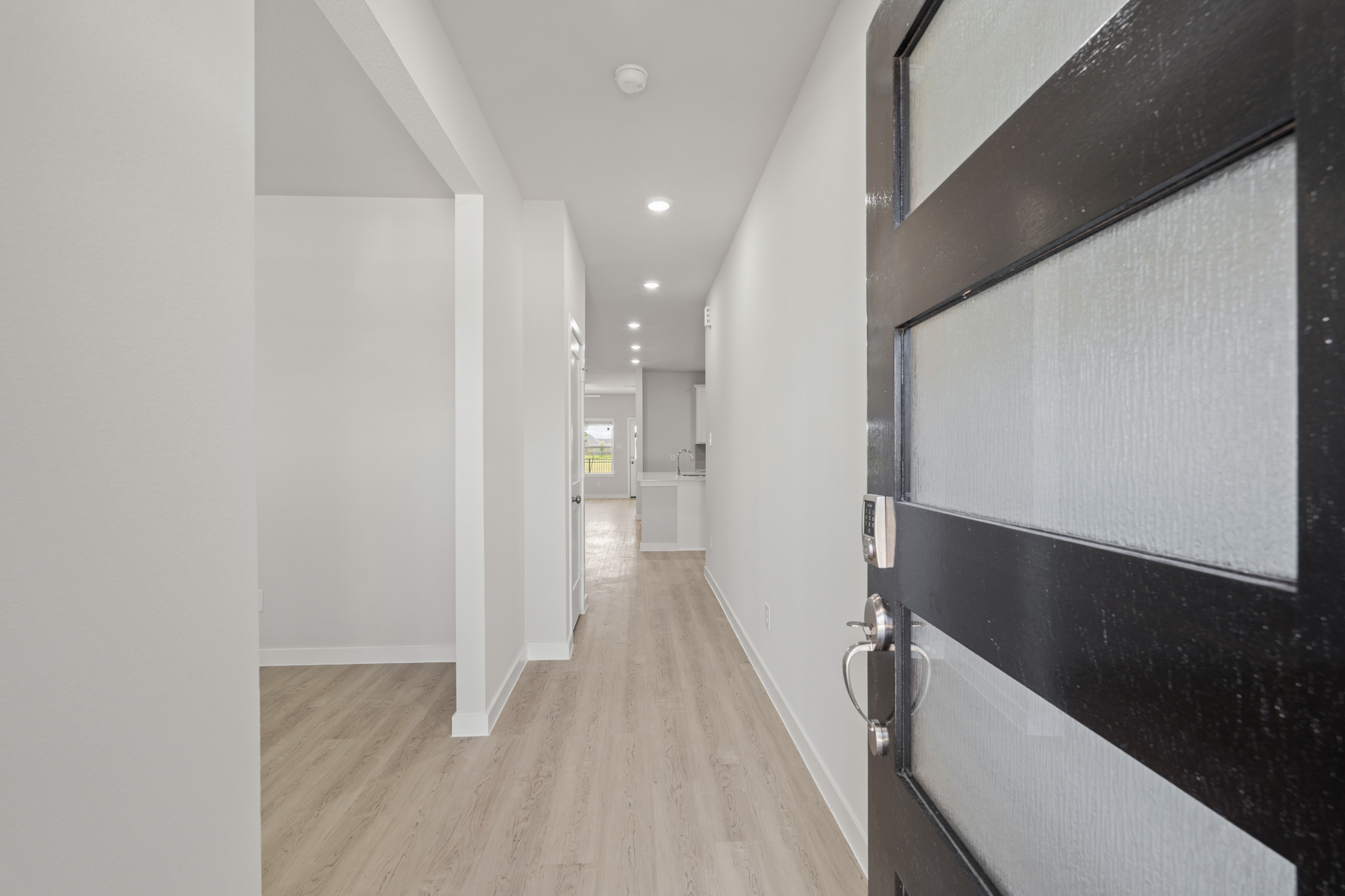 A hallway with black cabinets.