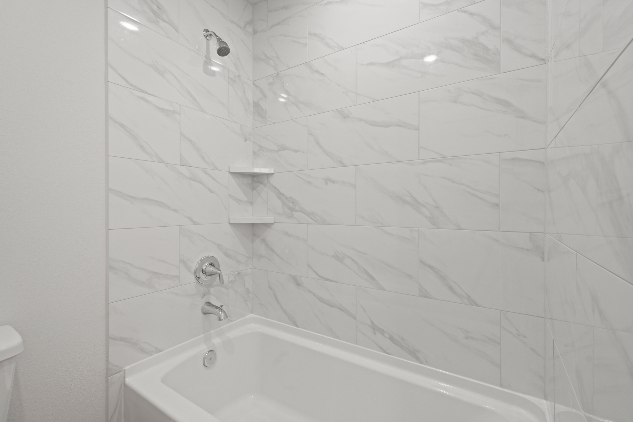 A white tiled bathroom.