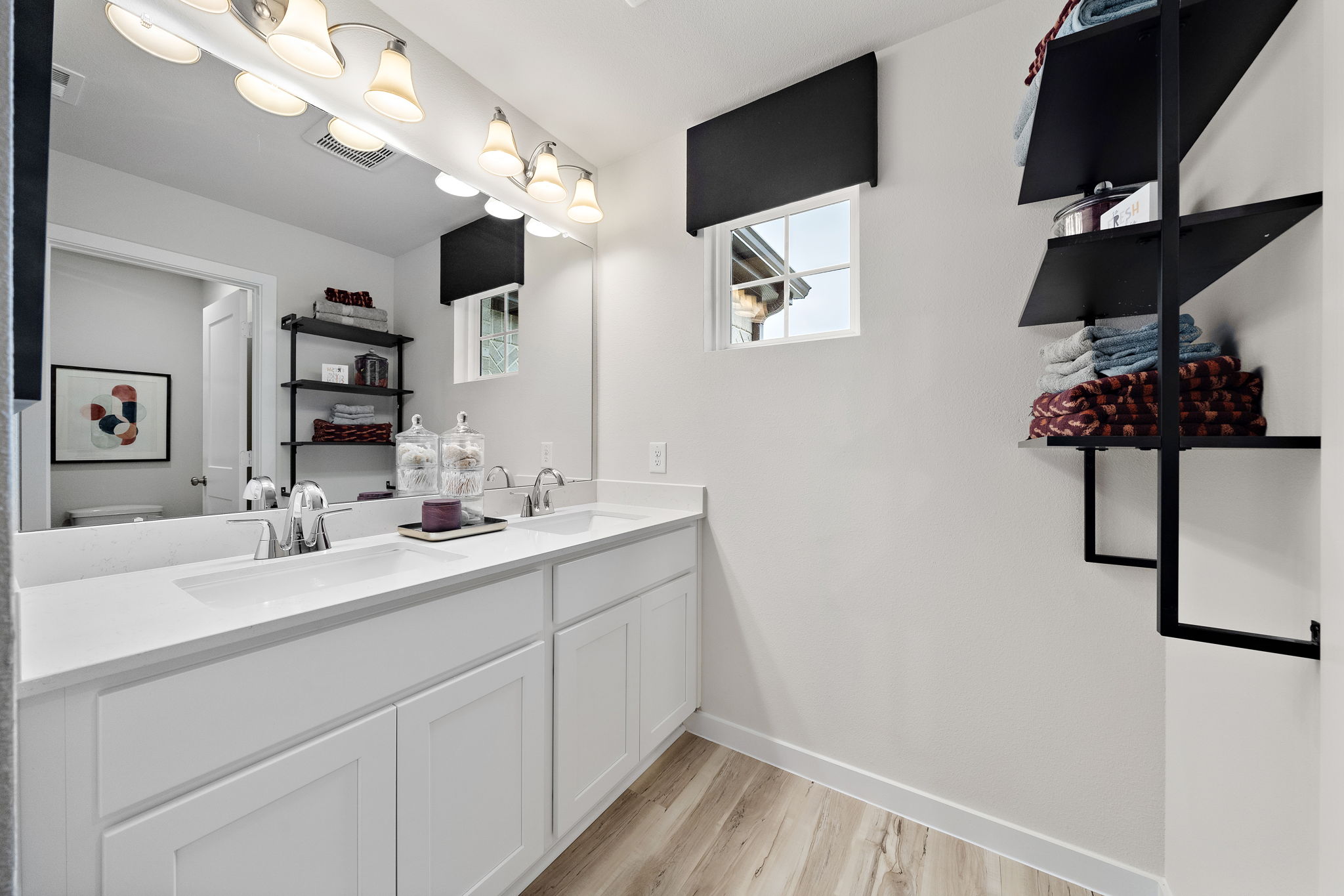 A bathroom with a sink and shelves.
